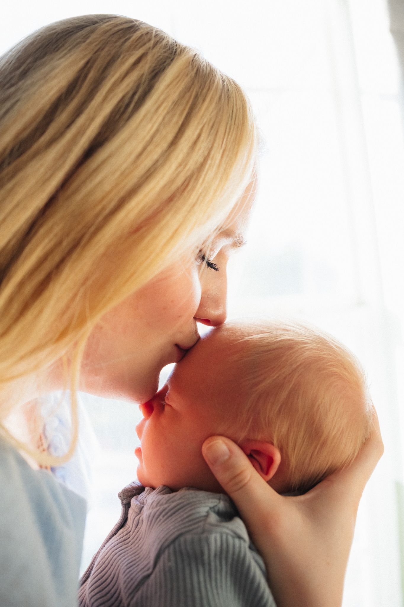 A tender moment captured in a series of close-up shots showing affectionate interaction between parent and baby.