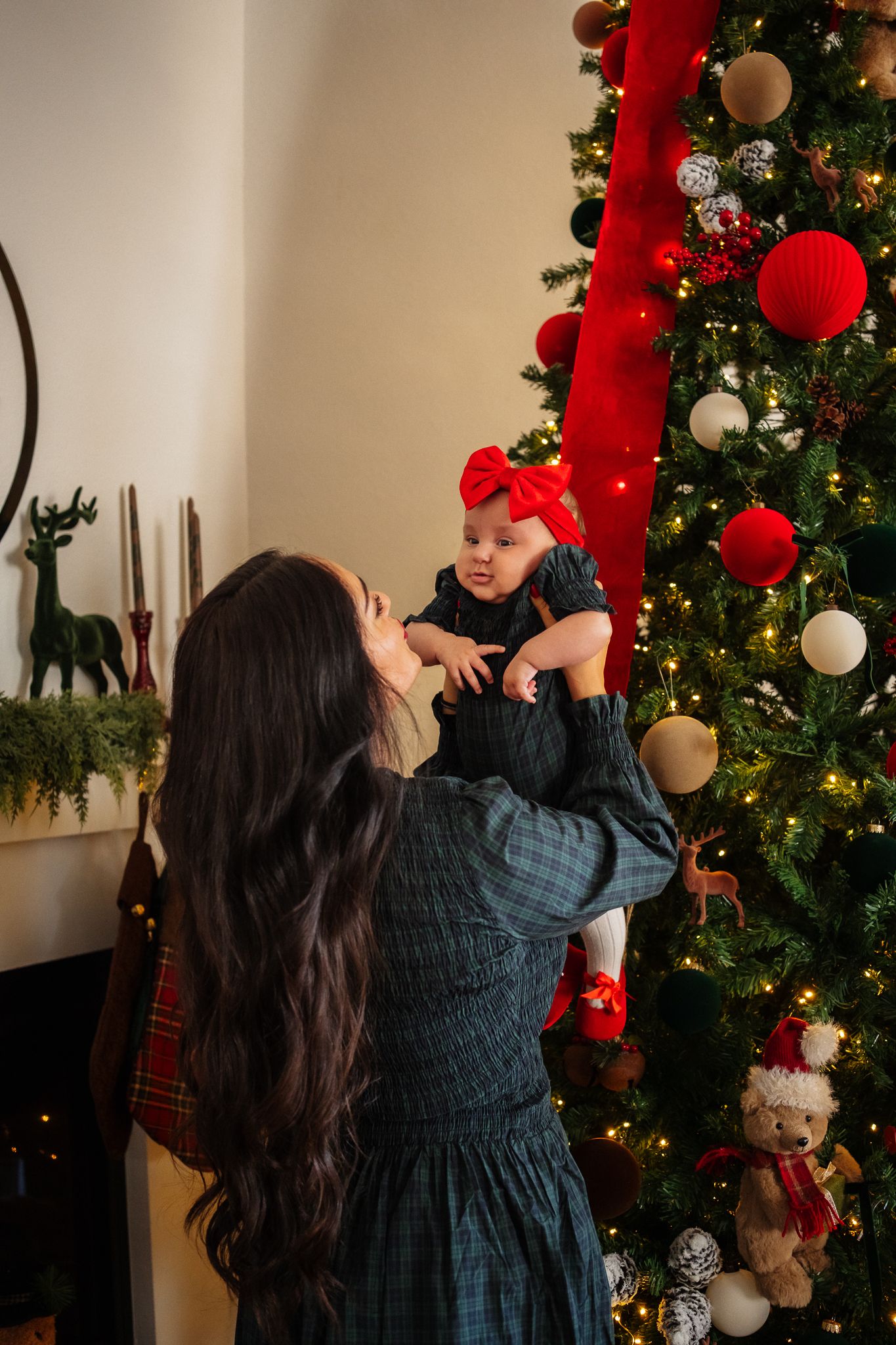 A series of photos showing someone decorating a Christmas tree with red and white ornaments in a festive living room setting.
