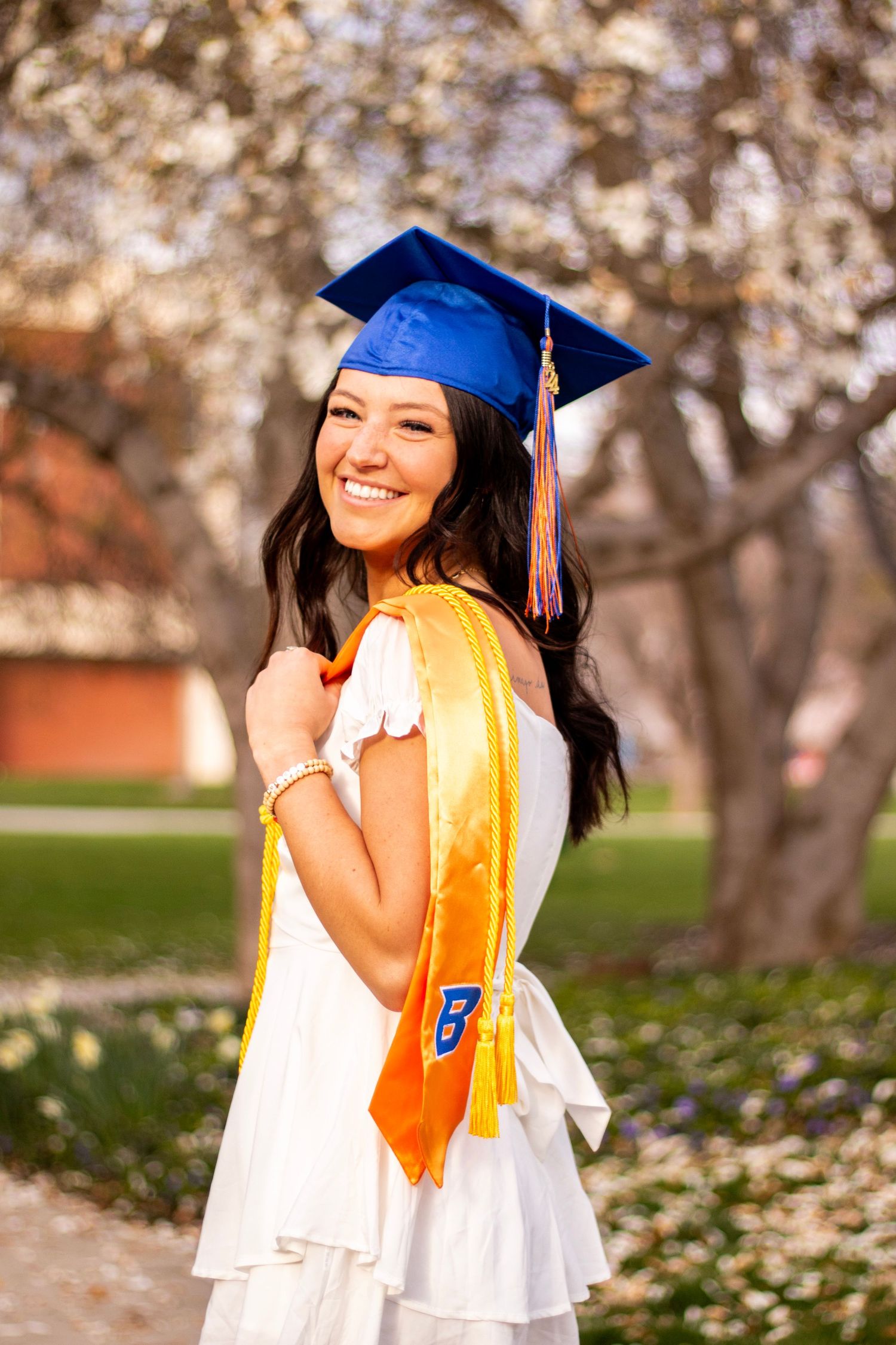 a grad posing with her cap and stole