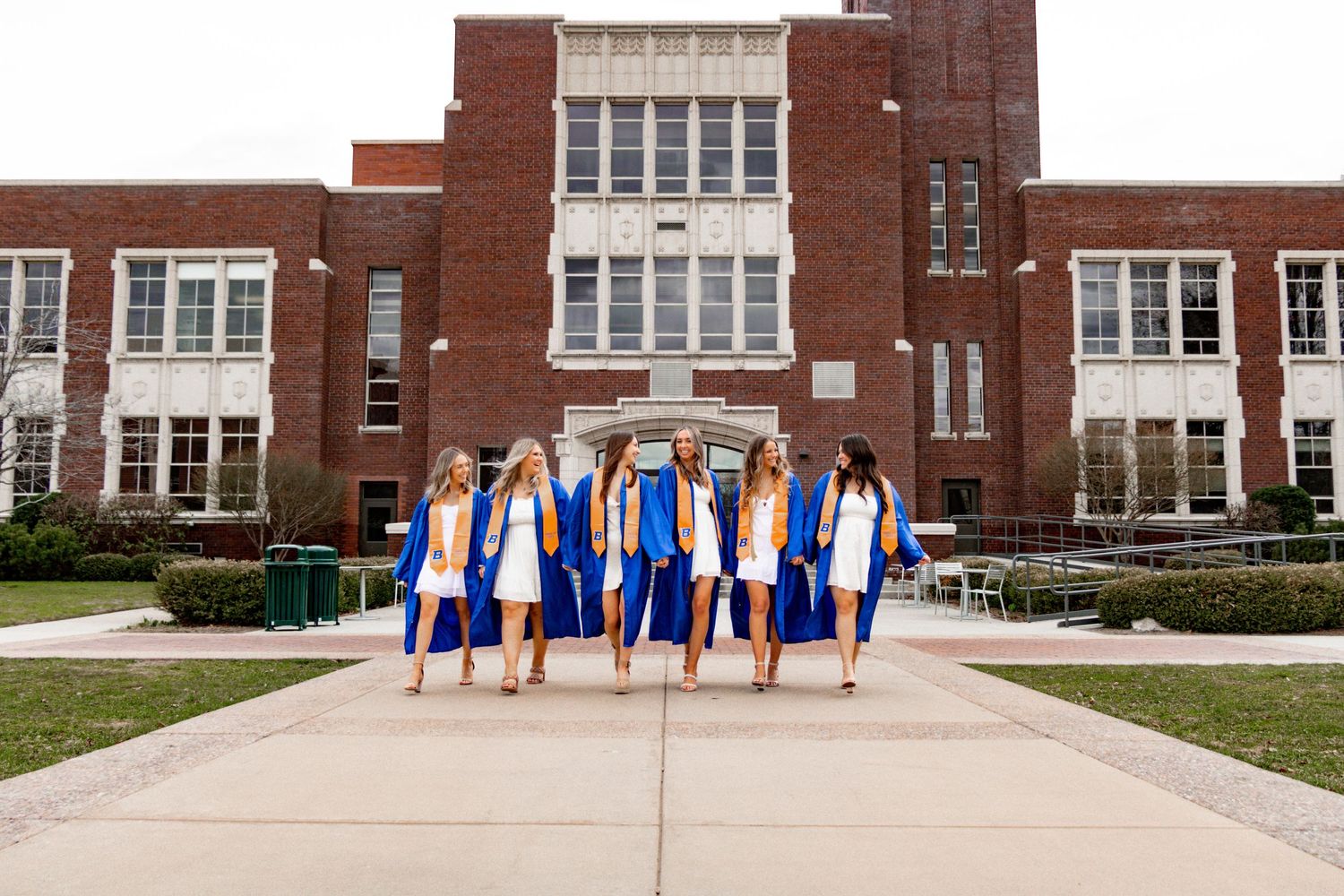 a group of grads walking towards the camera together