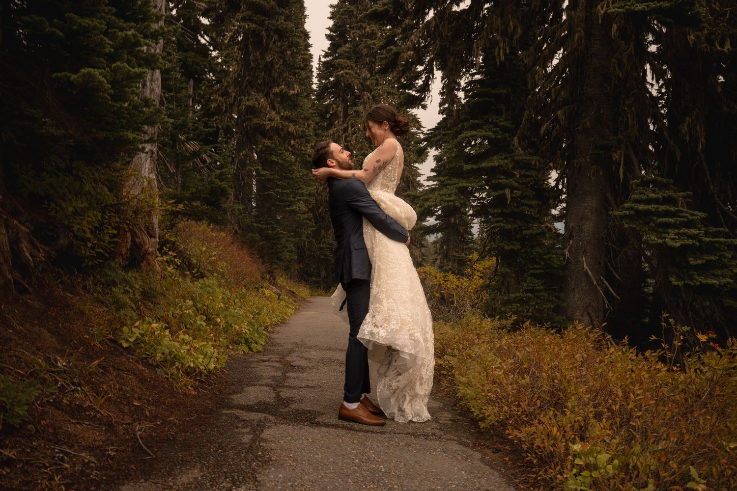 A couple dances on the skyline trail win their wedding attire in Mt. Rainier National Park.