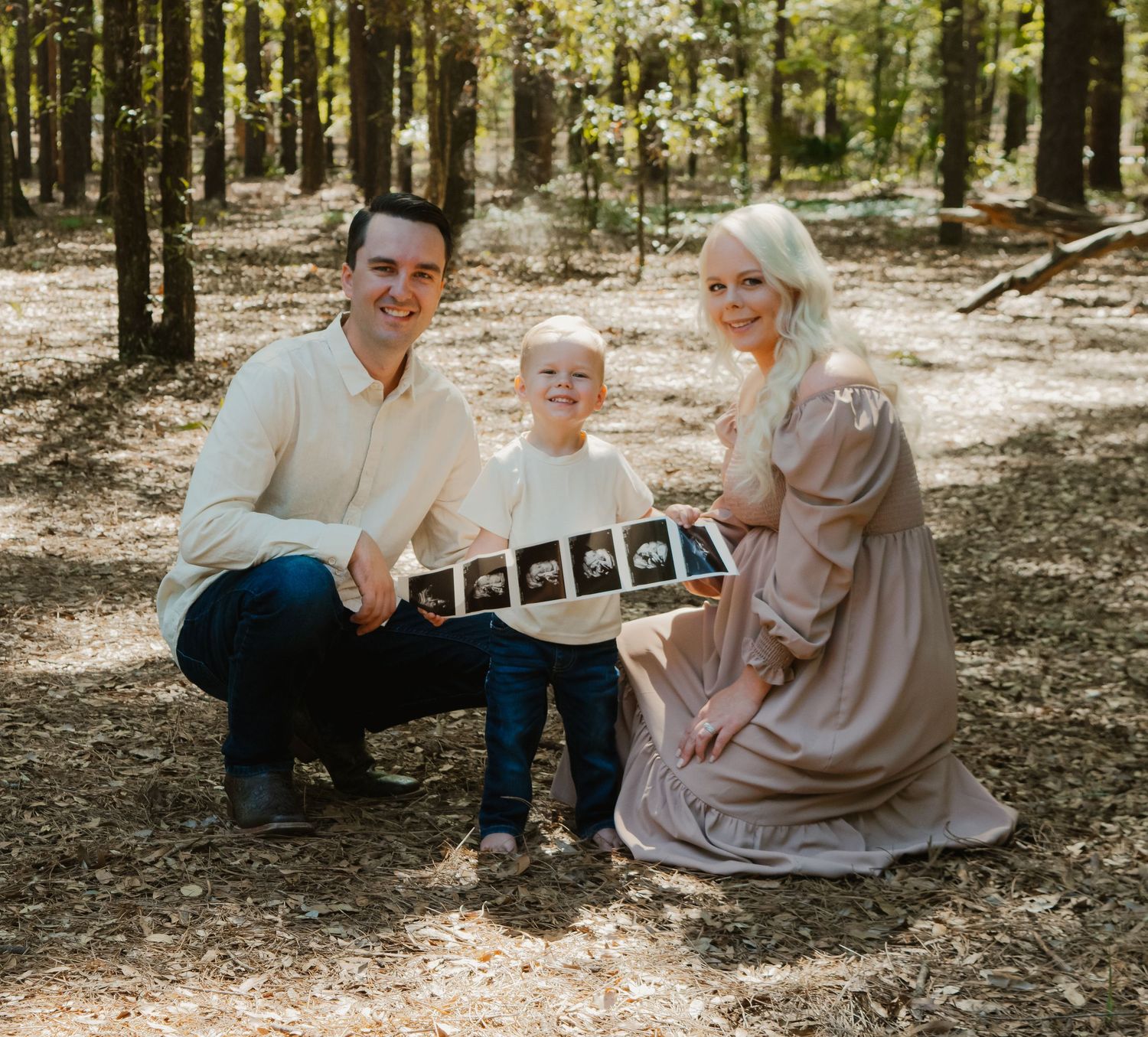 A heartwarming outdoor family photoshoot sequence in a sunlit wooded area showing a pregnancy announcement with ultrasound photos.