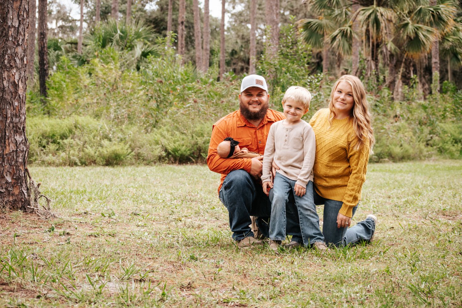 A series of casual outdoor family photos showing people sitting and interacting on grassy ground among pine trees.