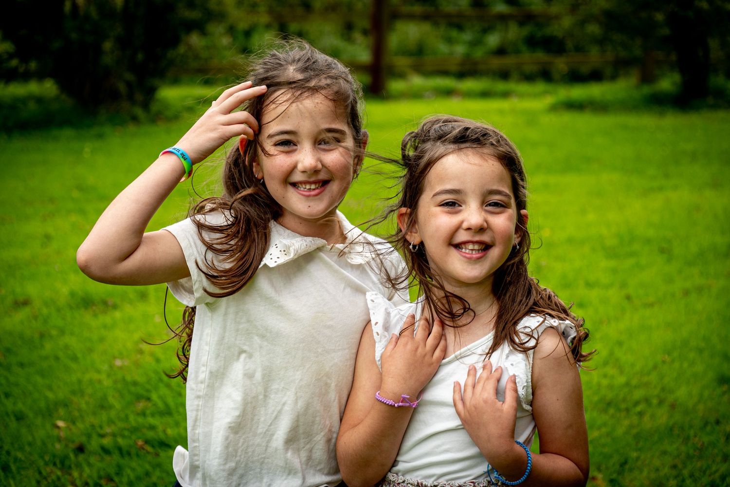 young children playing outside waterford family photographer hair blowing in the wind laughing  waterford