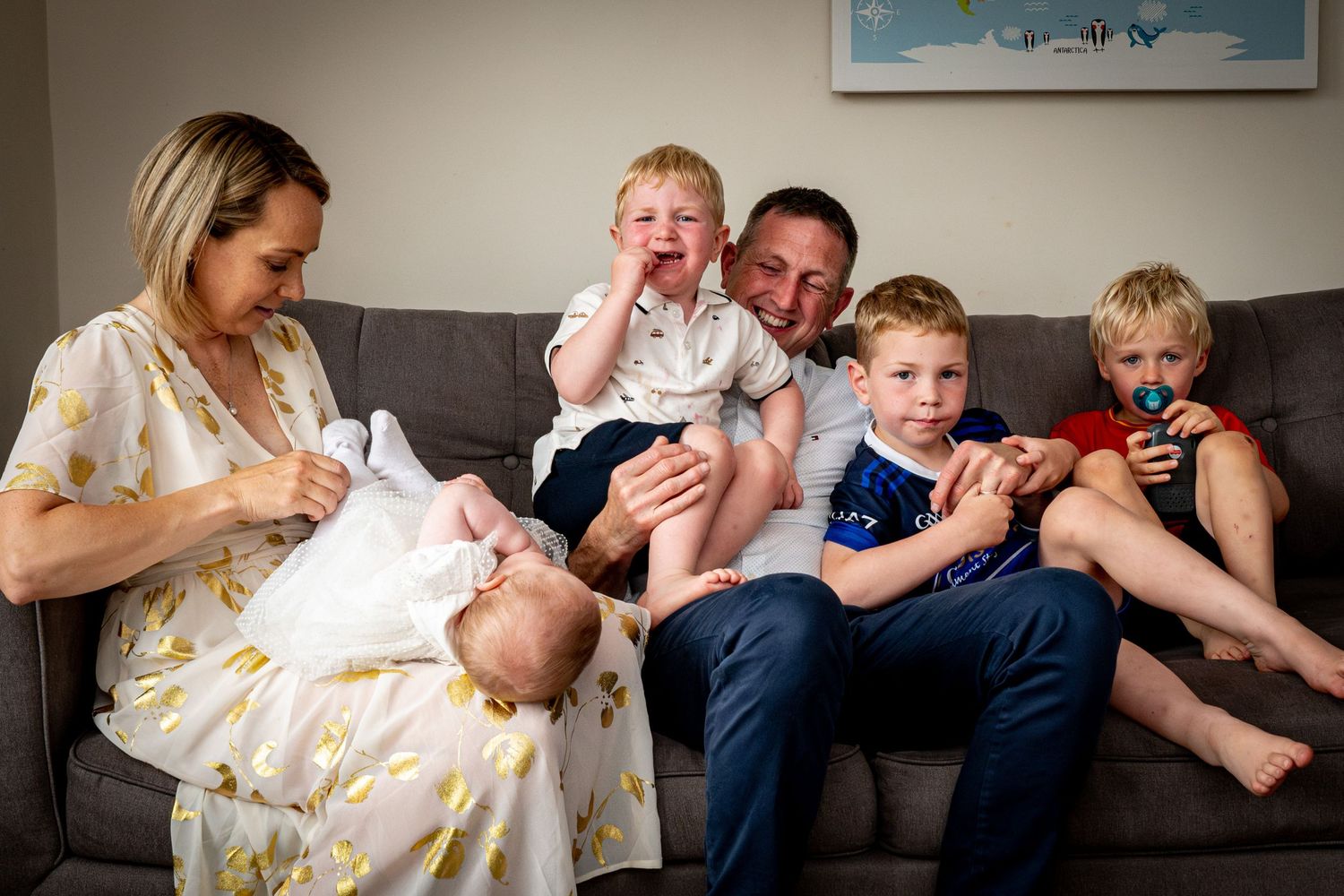 family photographer waterford at home on couch laughing smiling christening white dress