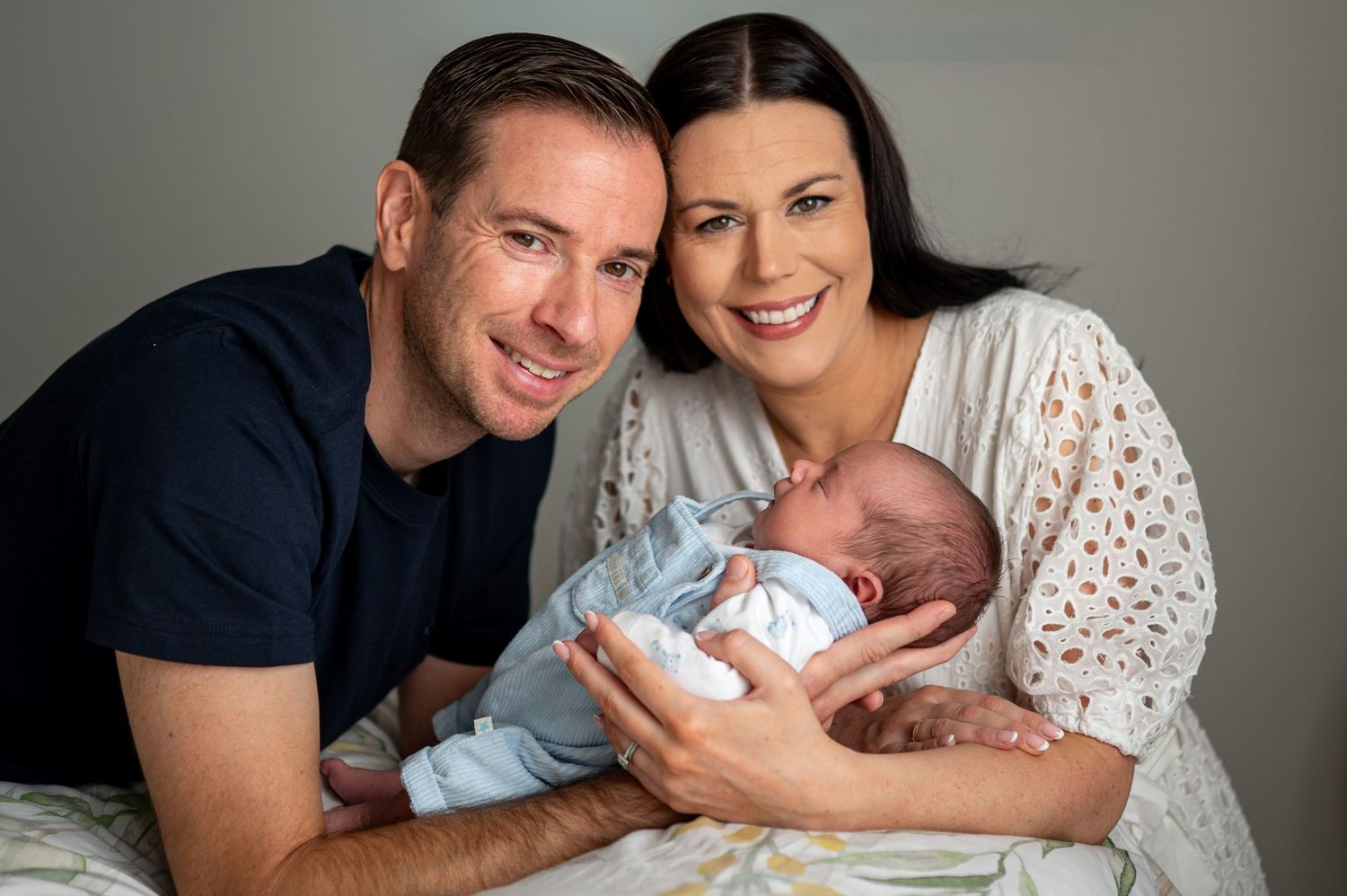 eleanor barry photography newborn waterford munster baby in blue suit held by dad man in white dress