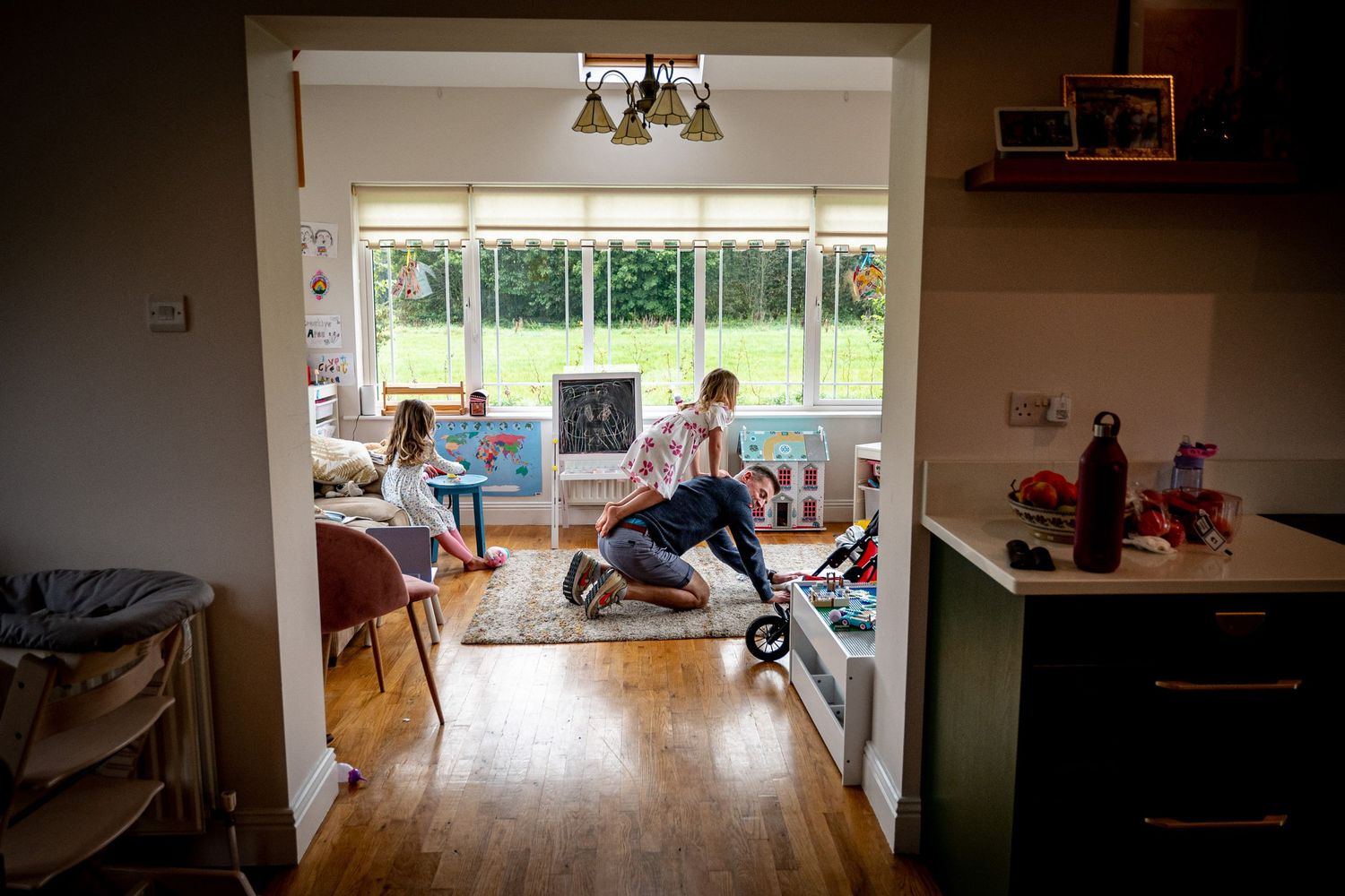 family documentary photography playning with dad in the toy room  waterford