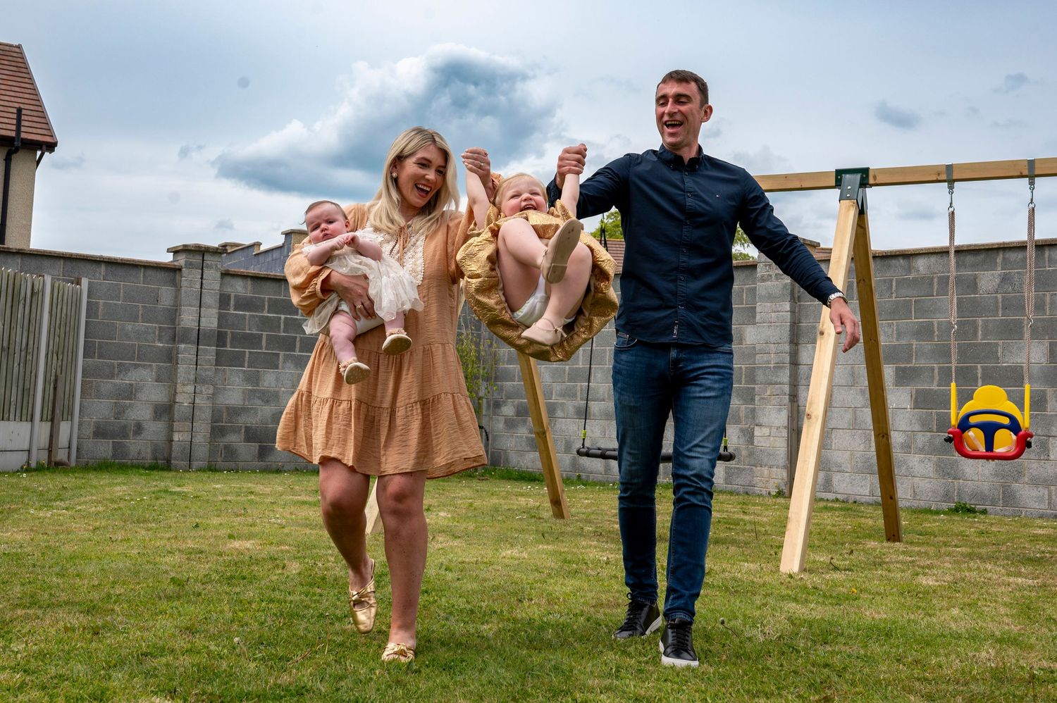 eleanor barry family photographer waterford family playing in the garden smiling