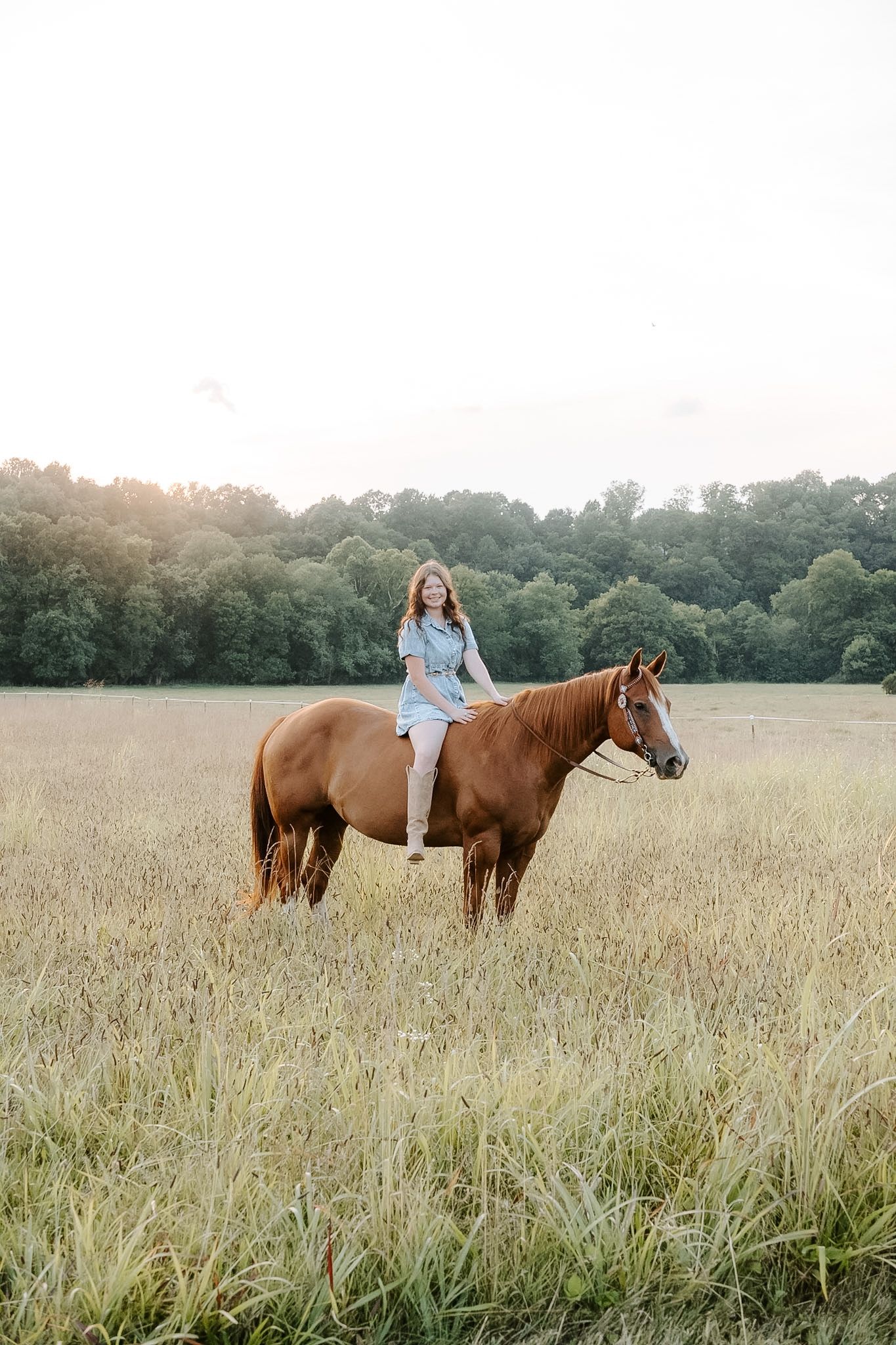 Girl riding horse in denim dress