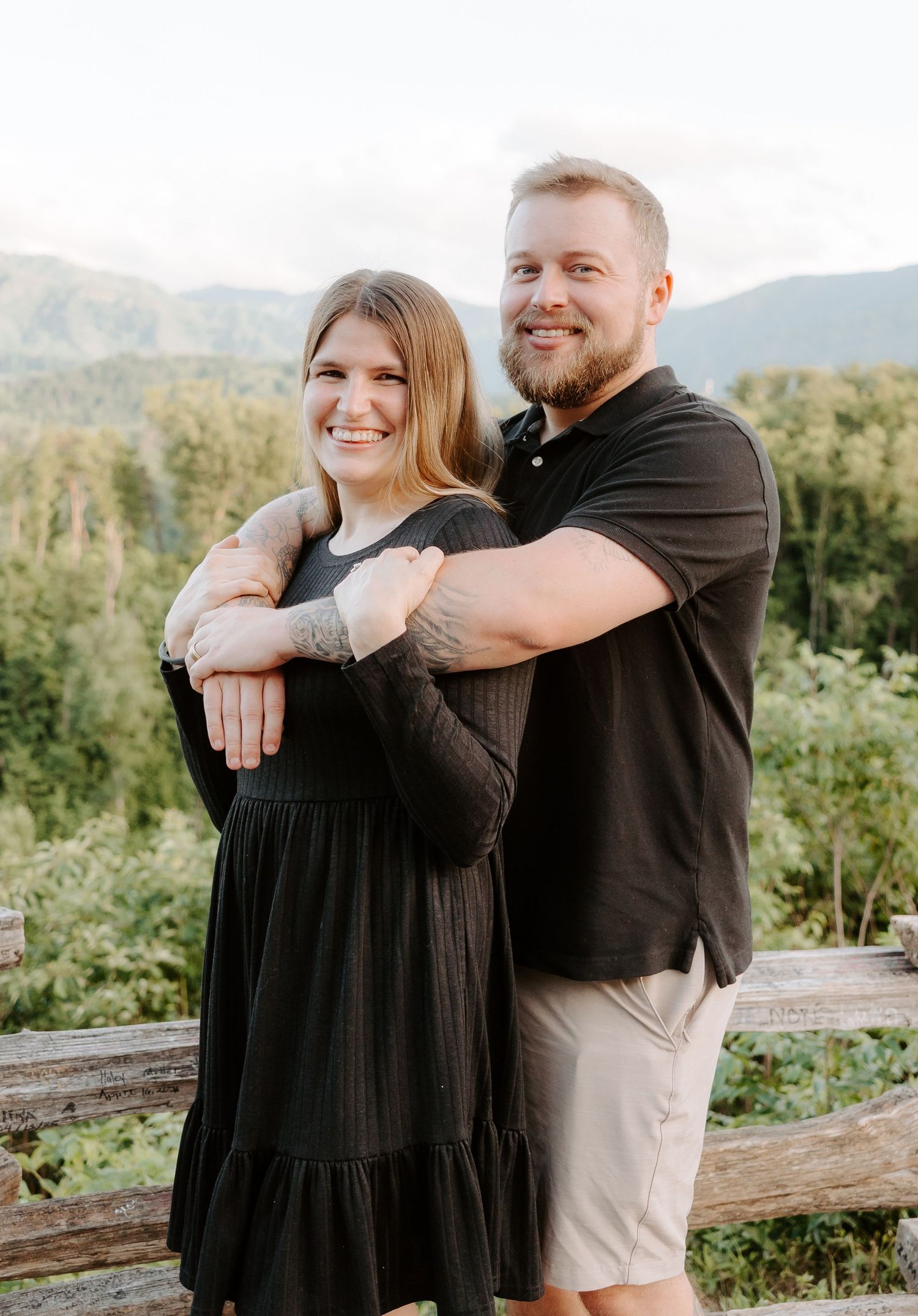 Husband wrapping his arms around wife