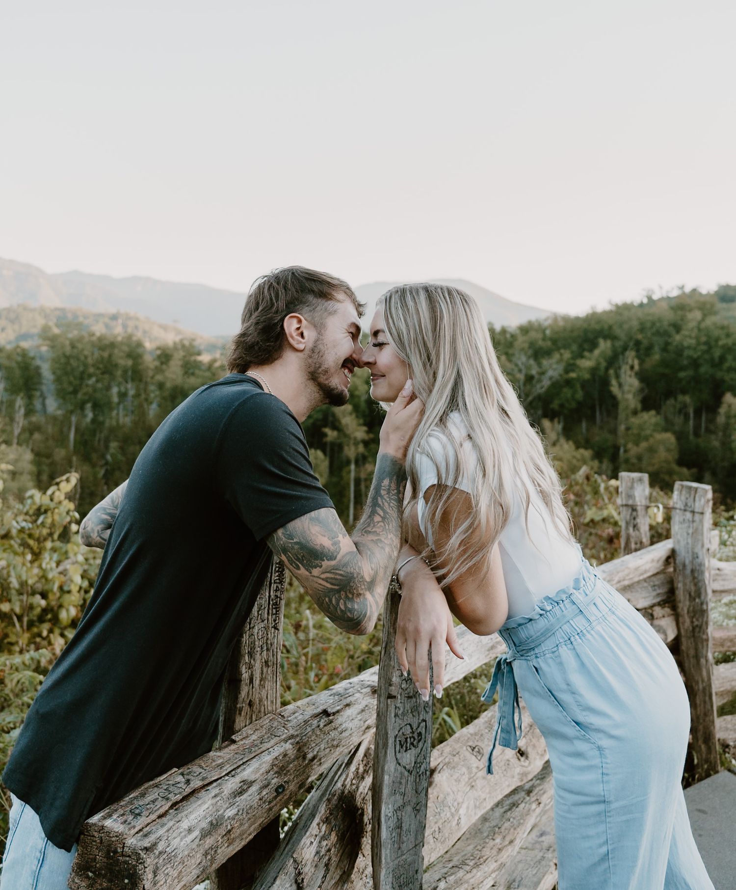 Couple kissing with mountains in the background