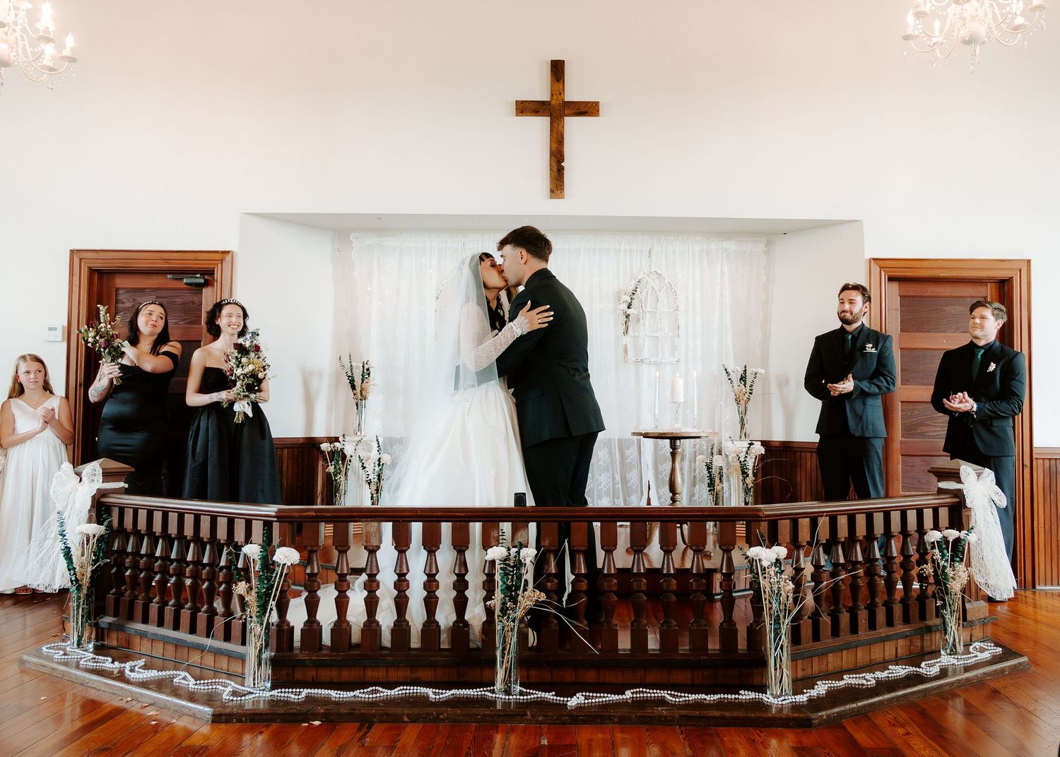 Bride and groom kissing at altar