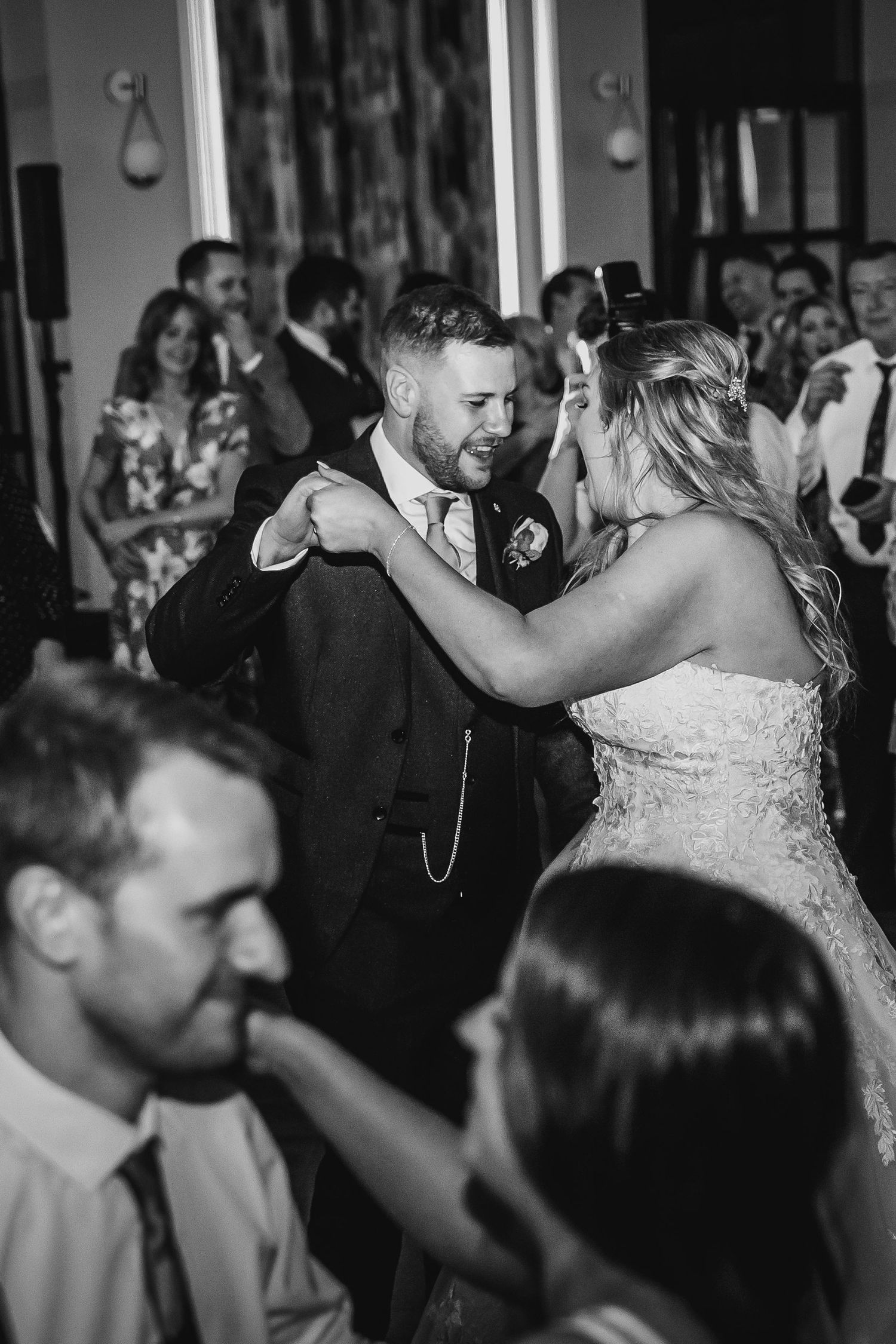 Black and white image of bride and groom sharing an intimate first dance at wedding reception.