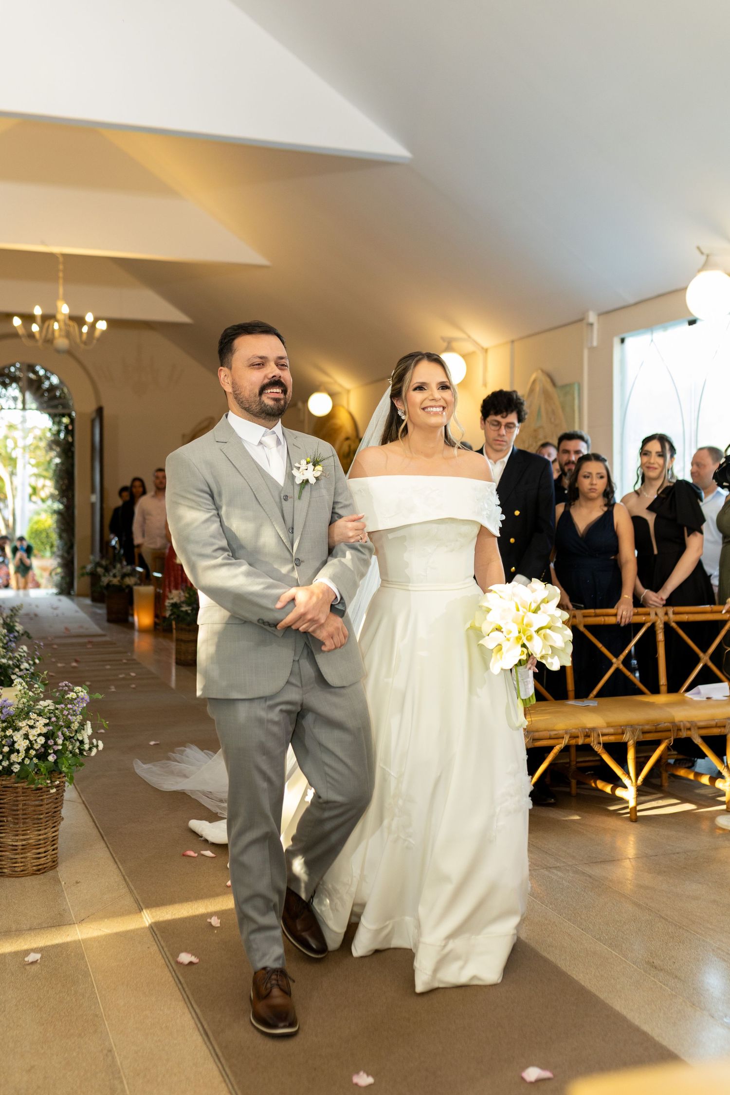 Bride and groom walking down the aisle together in a elegant church wedding ceremony.
