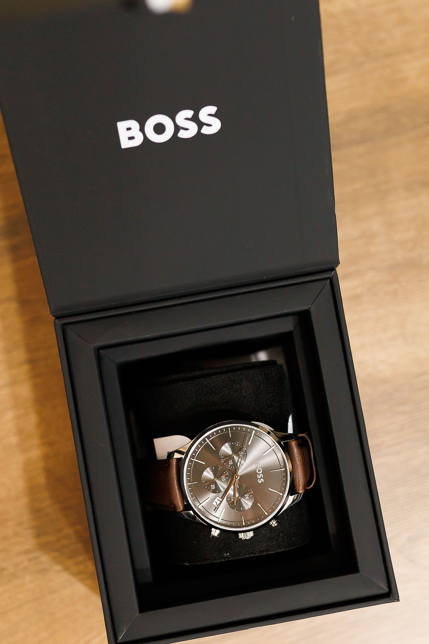 Hugo Boss chronograph watch with brown leather strap in black gift box.