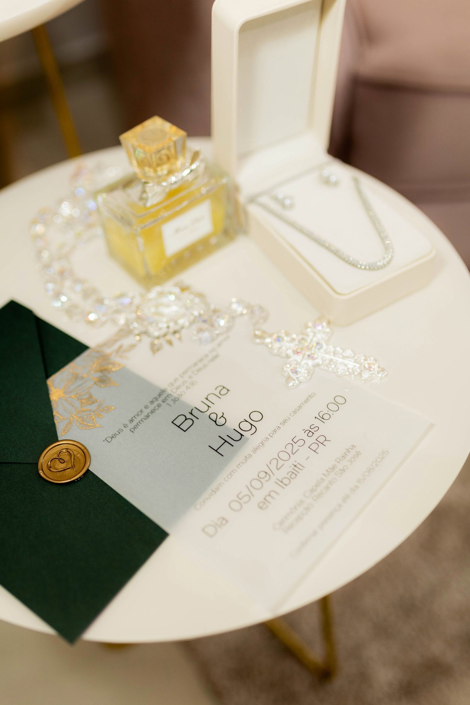 Wedding invitation for Bruna and Hugo with perfume, pearl necklace, and crystal accessories.