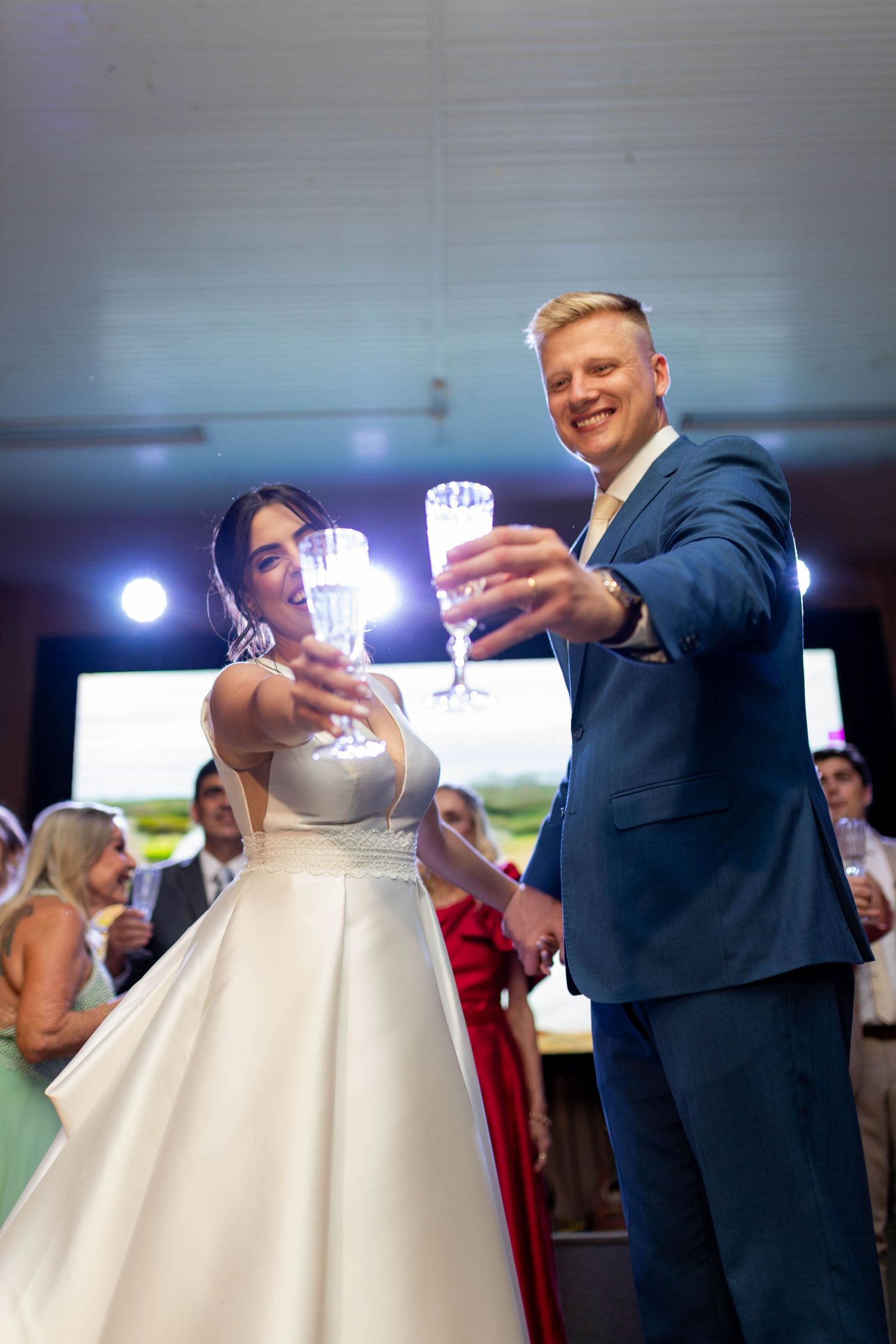 Bride and groom toasting with crystal champagne glasses at their wedding reception celebration.