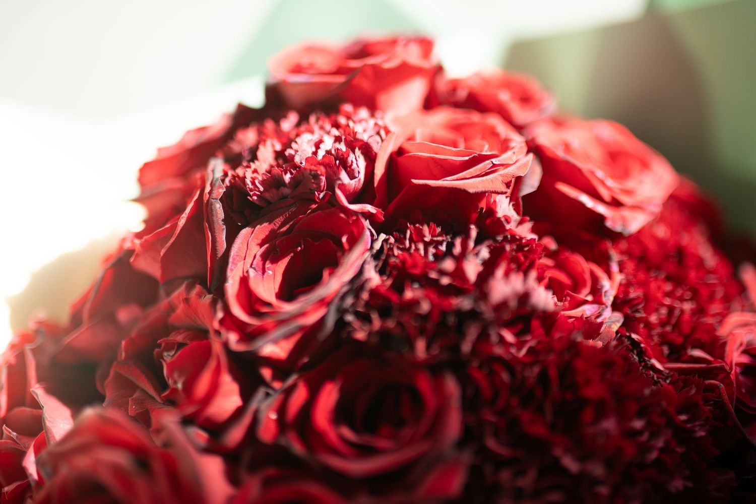A lush bouquet of deep red roses and carnations, perfect for romantic occasions or Valentine's Day gifts.