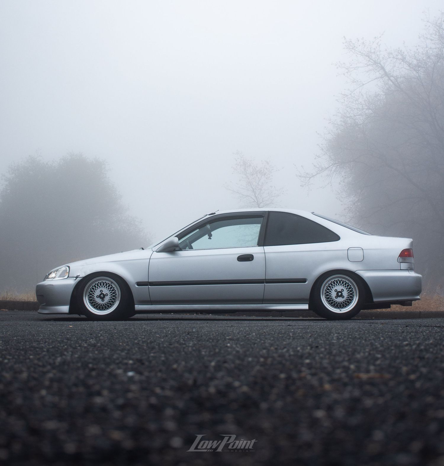Silver Honda Civic photographed on a foggy day