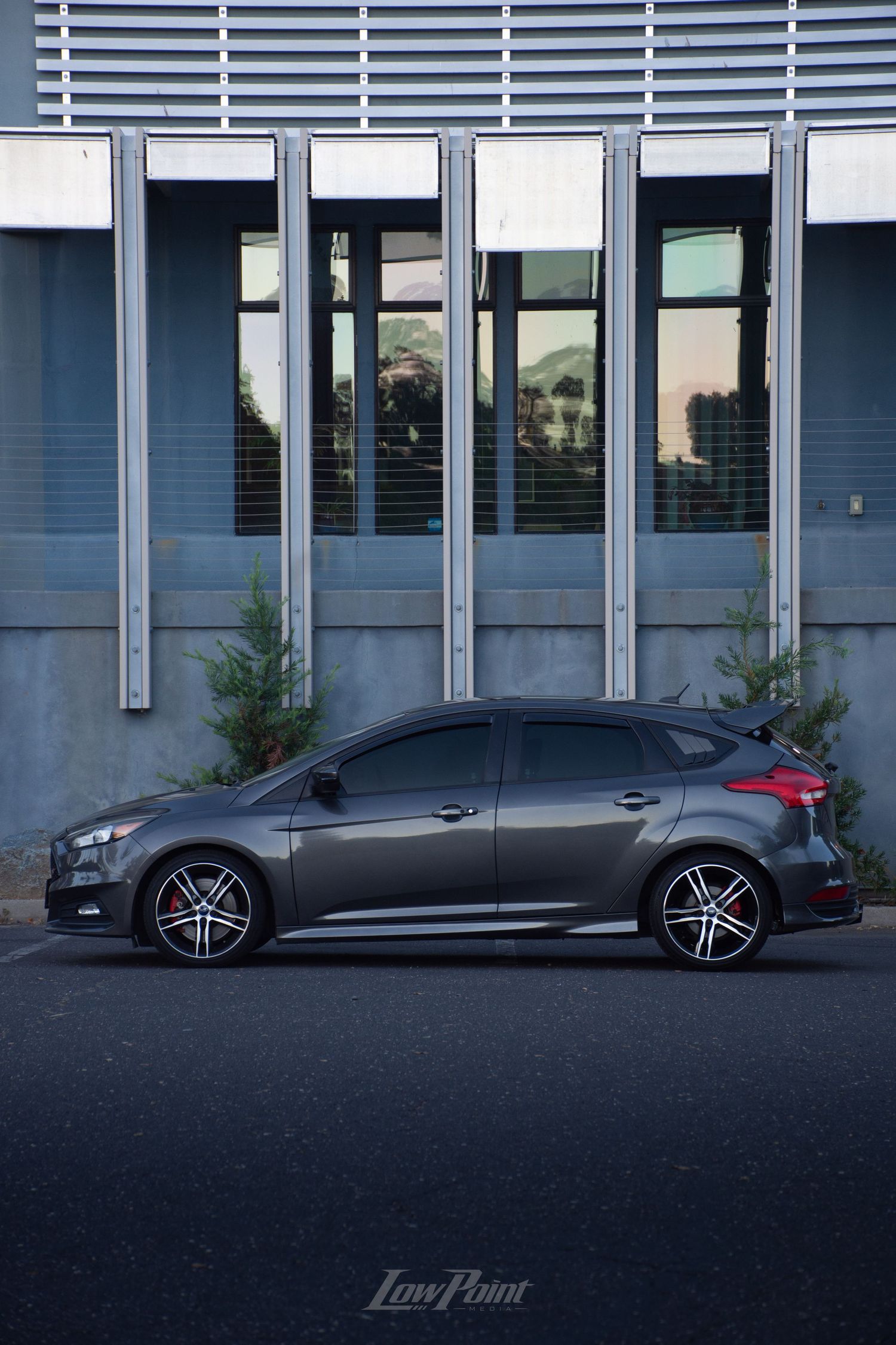 Magnetic Grey Ford Focus ST photographed in front of modern building with metal accents