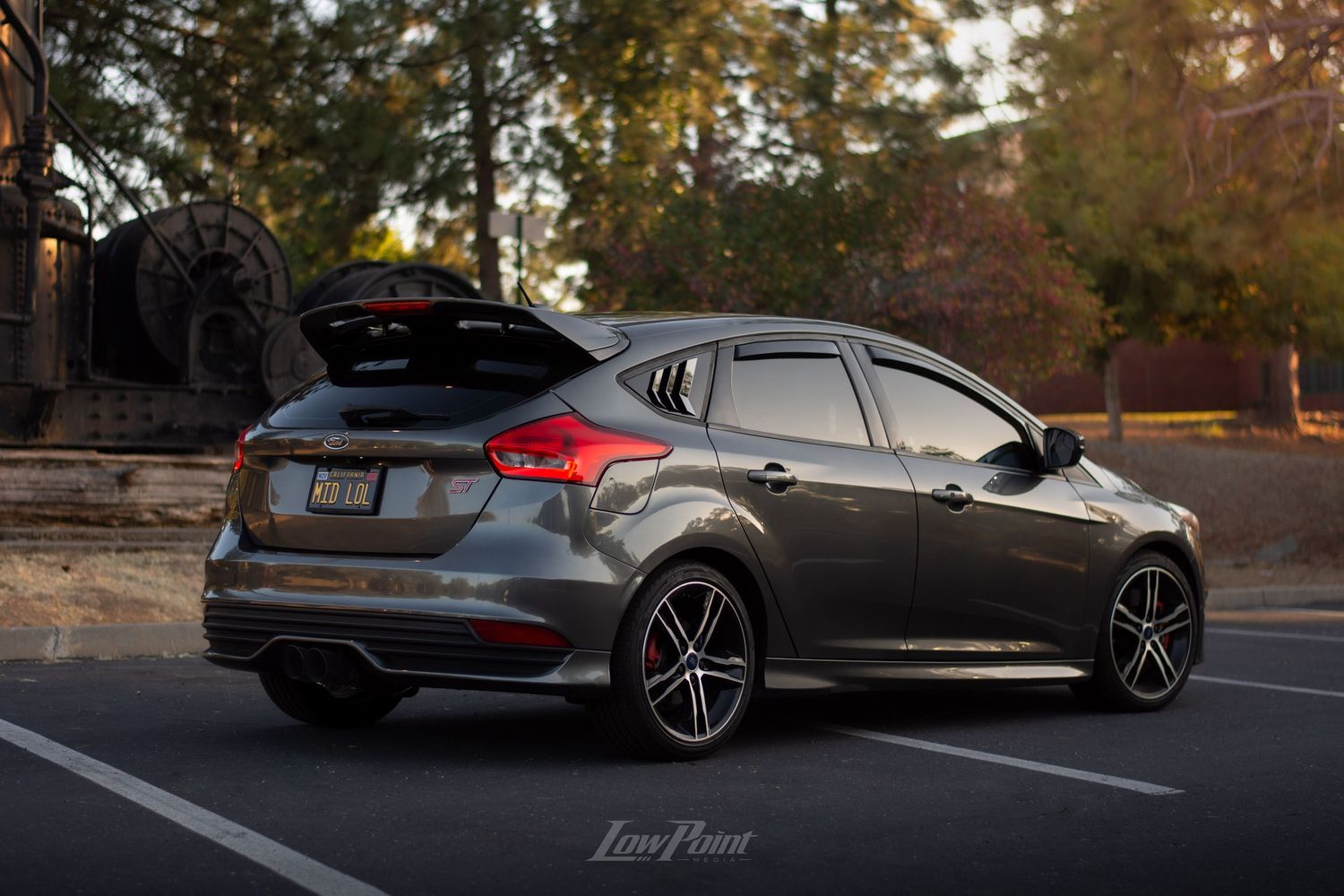 Magnetic Grey Ford Focus ST photographed in front trees at golden hour