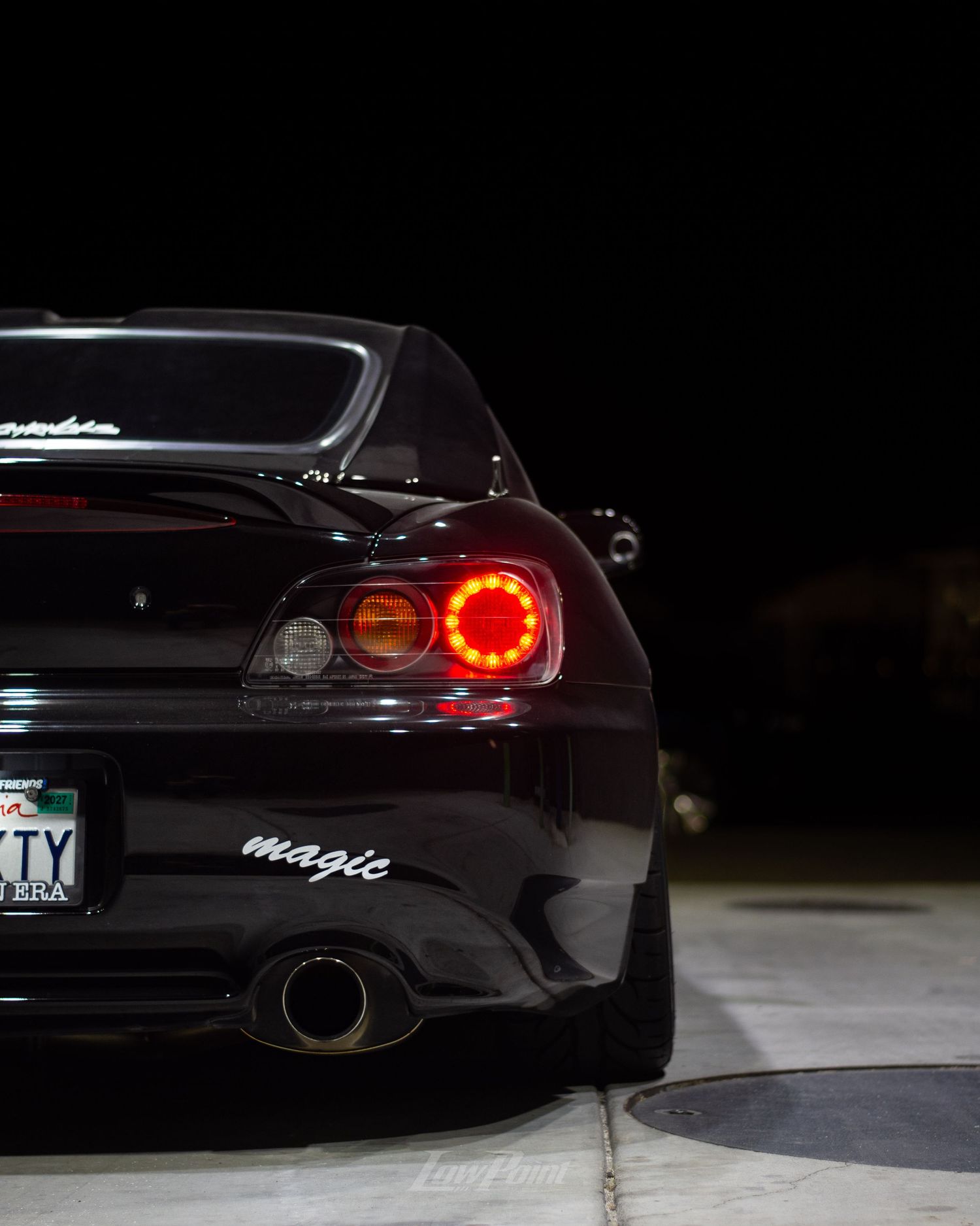 Black Honda S2000 photographed at night at a gas pump with white Work wheels