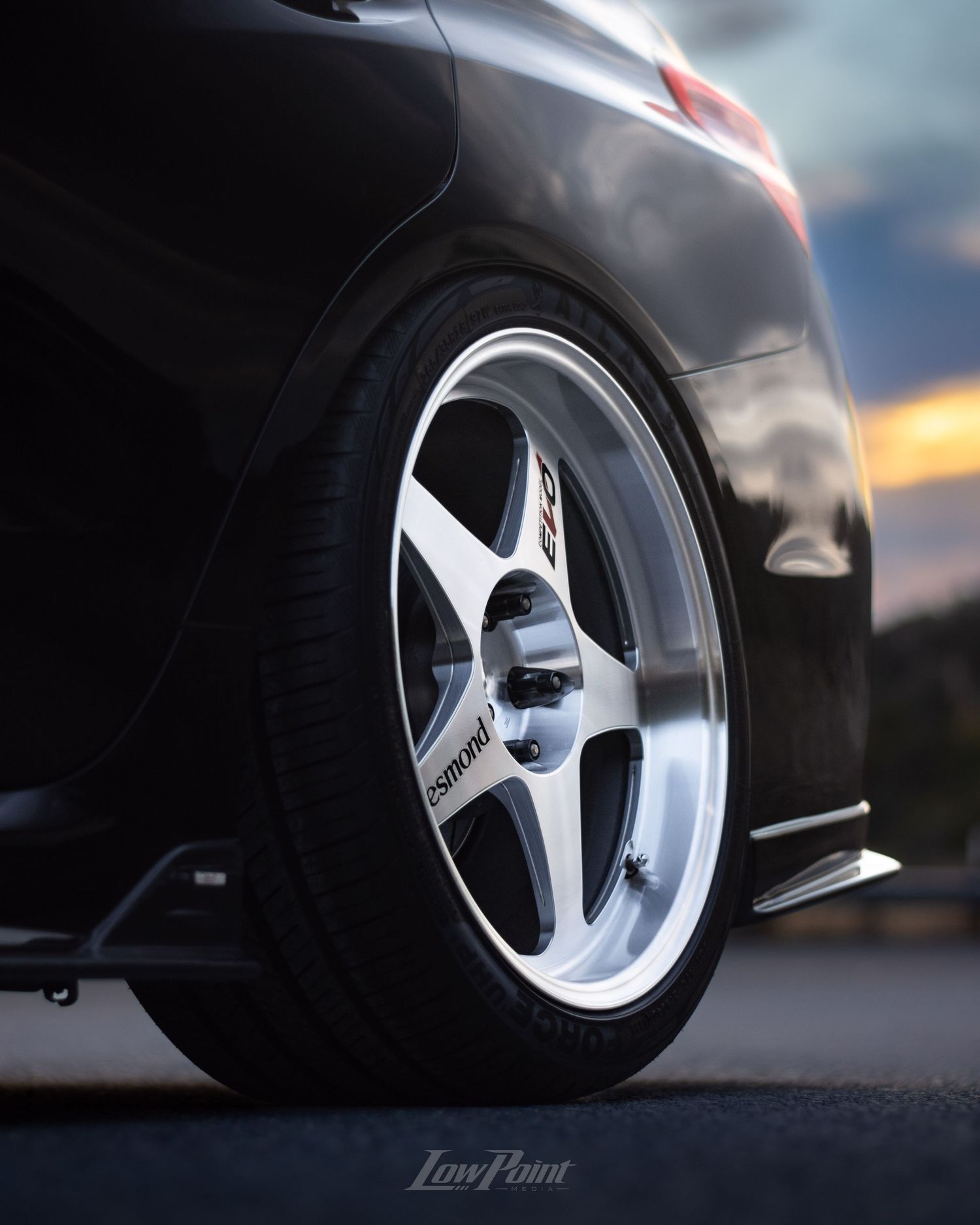 Black Subaru WRX photographed on the side of a northern California road with a blue and orange sunset behind
