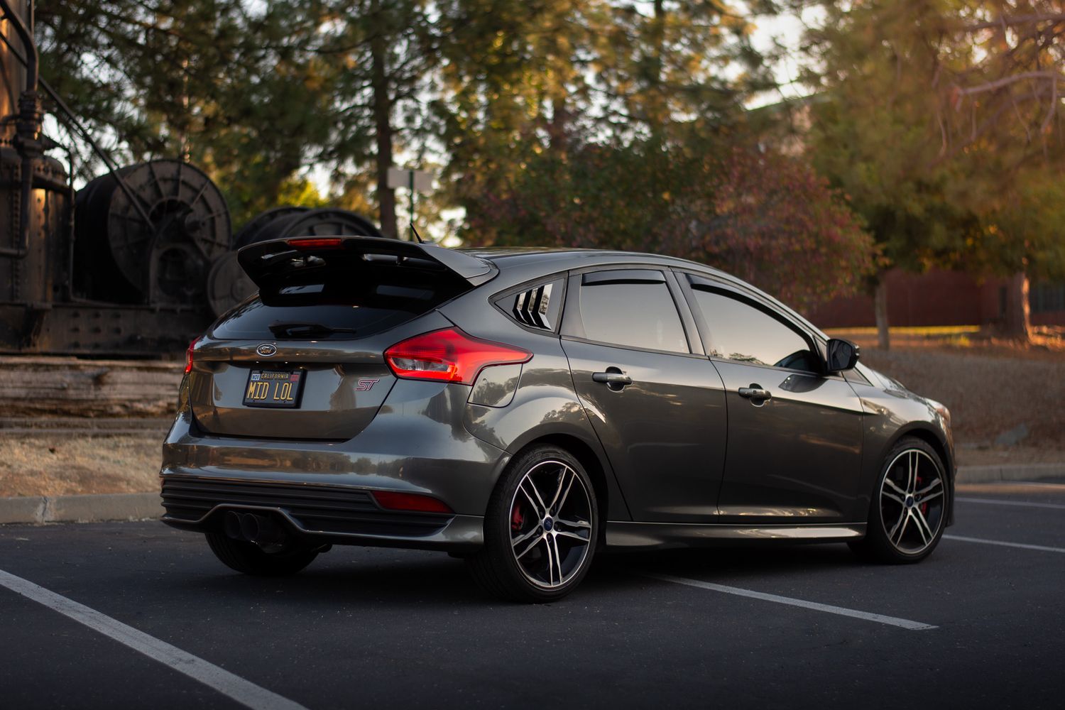 Magnetic Grey Ford Focus ST photographed in front trees at golden hour