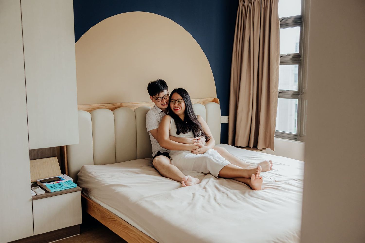 Couple's intimate lifestyle photos captured in minimalist bedroom setting.