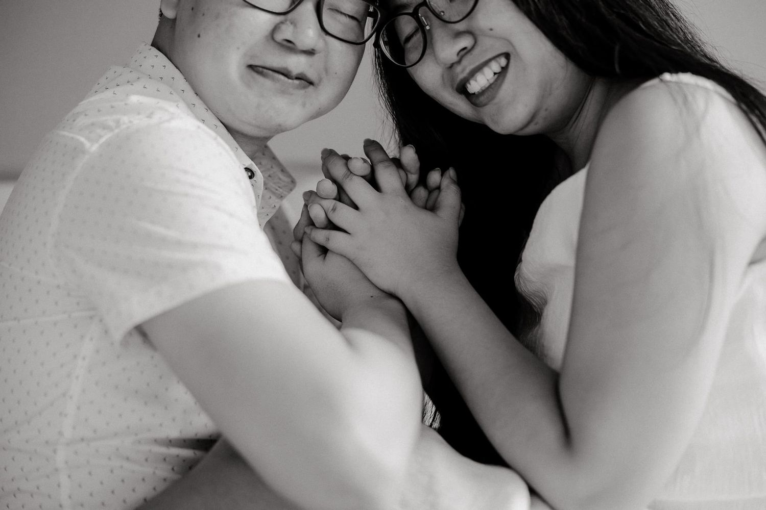 Black and white intimate portrait of couple sharing tender moments.