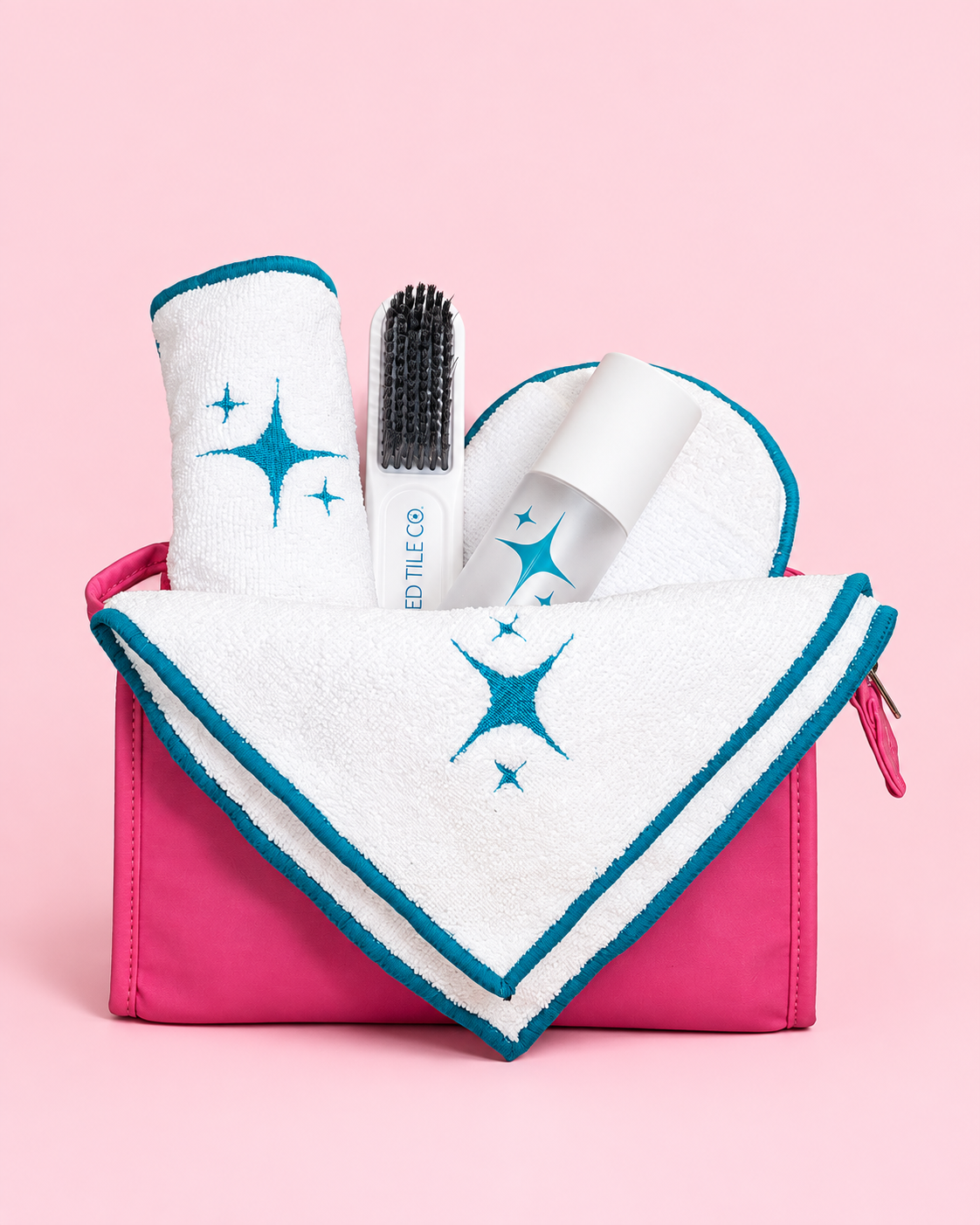 A studio product photo of a cleaning kit with a pink yellow backdrop.