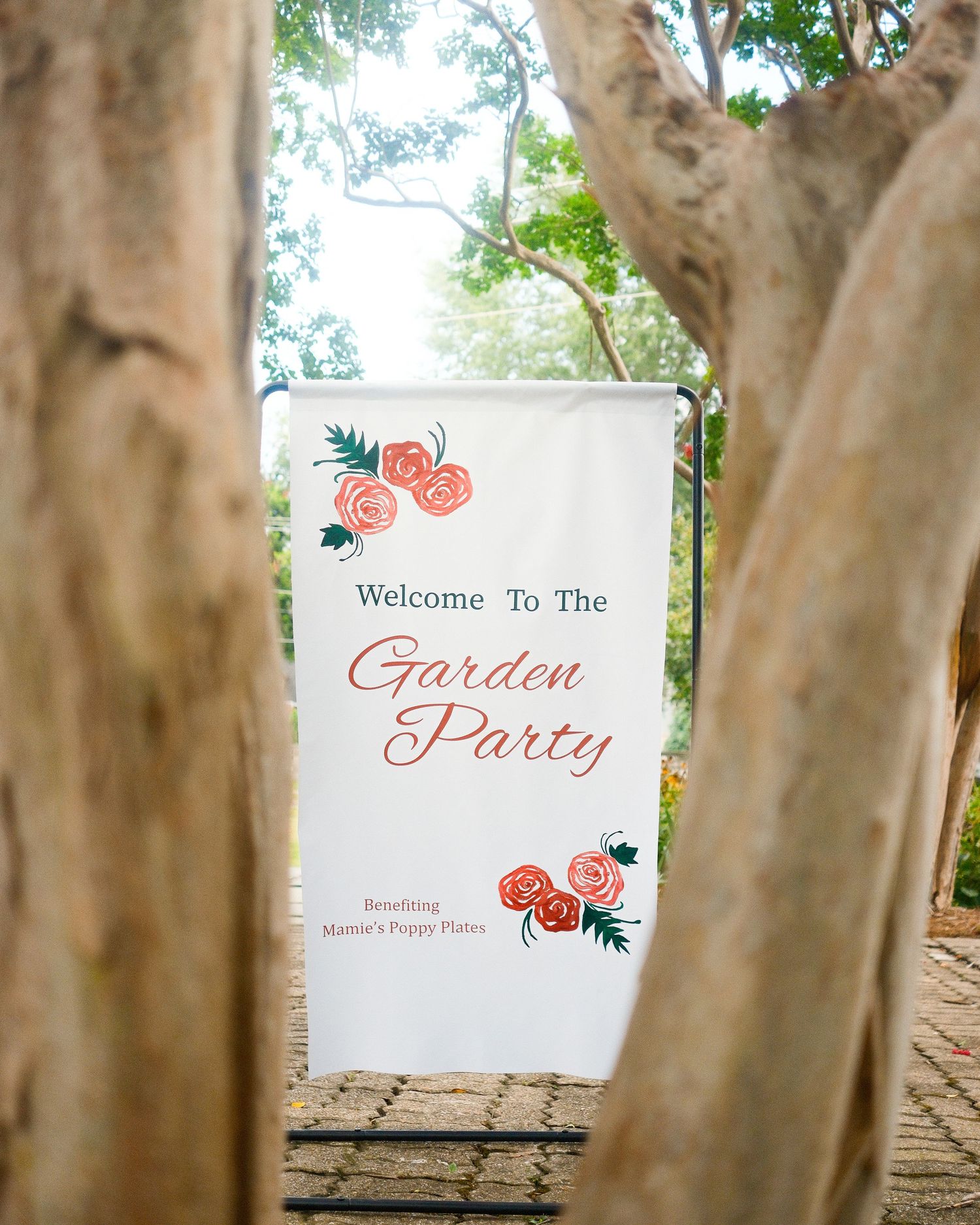 An event banner in-between tree branches.