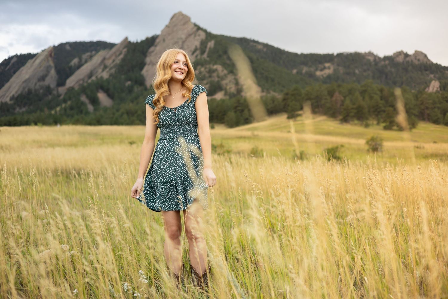Candid walking shot through tall grass with mountains in background.