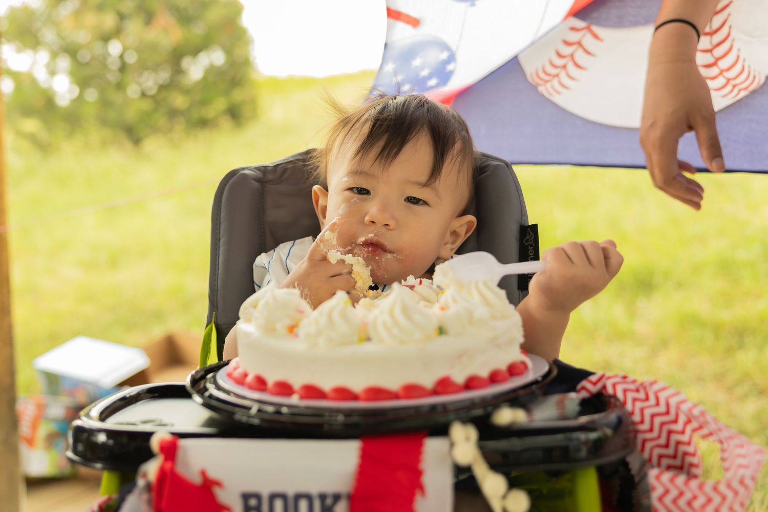 Children enjoying desserts at party with red and white checkered decorations.