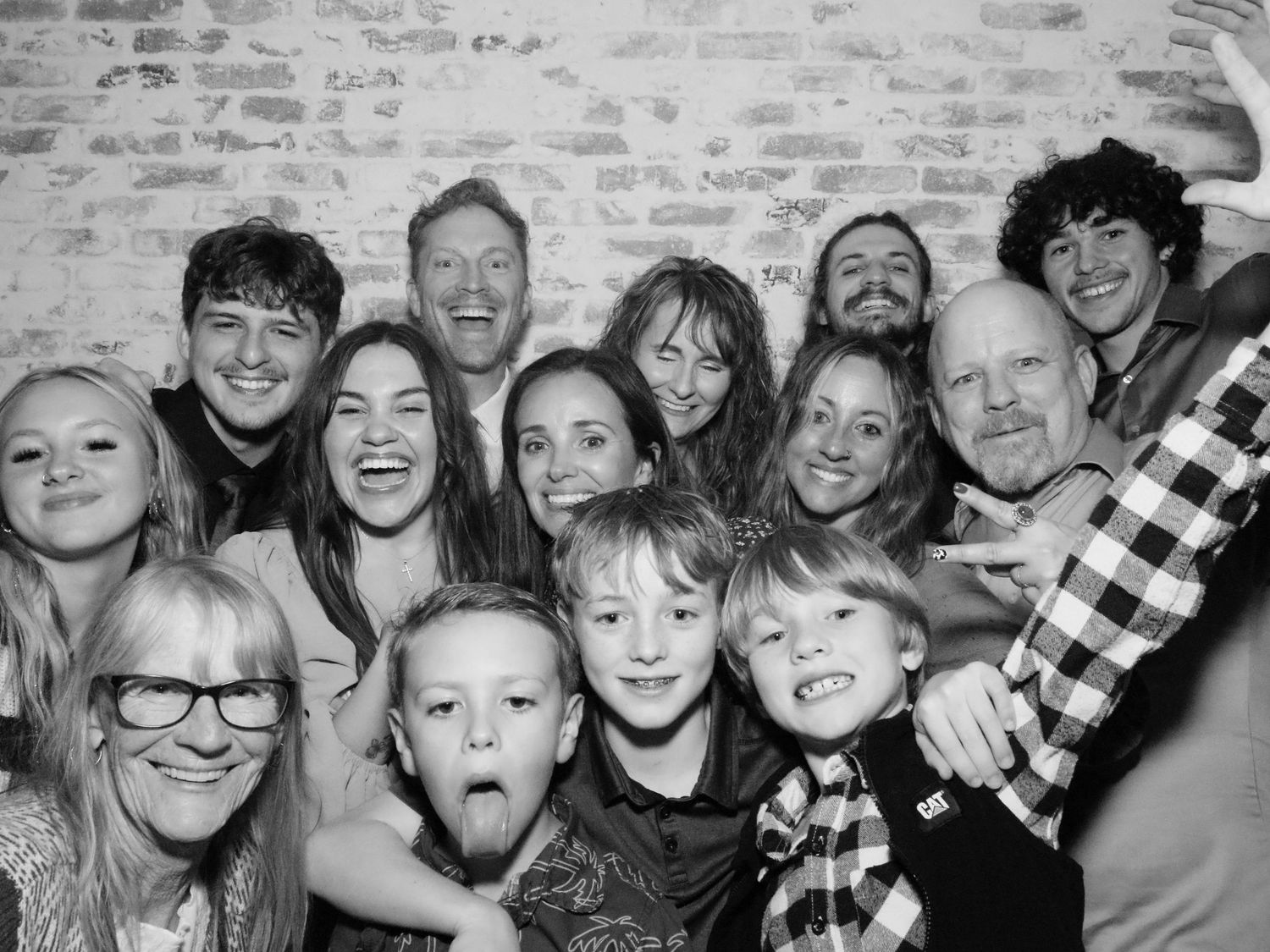 Black and white group photo showing a large family gathering with joyful expressions.