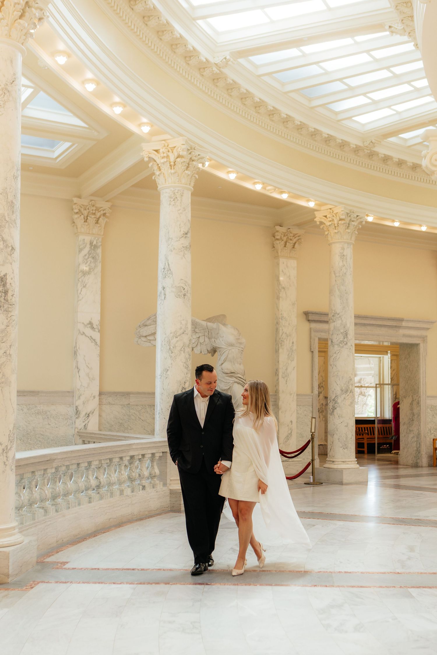 Interior photo series showing a grand ornate hallway with white columns and decorative details in a luxurious event space.