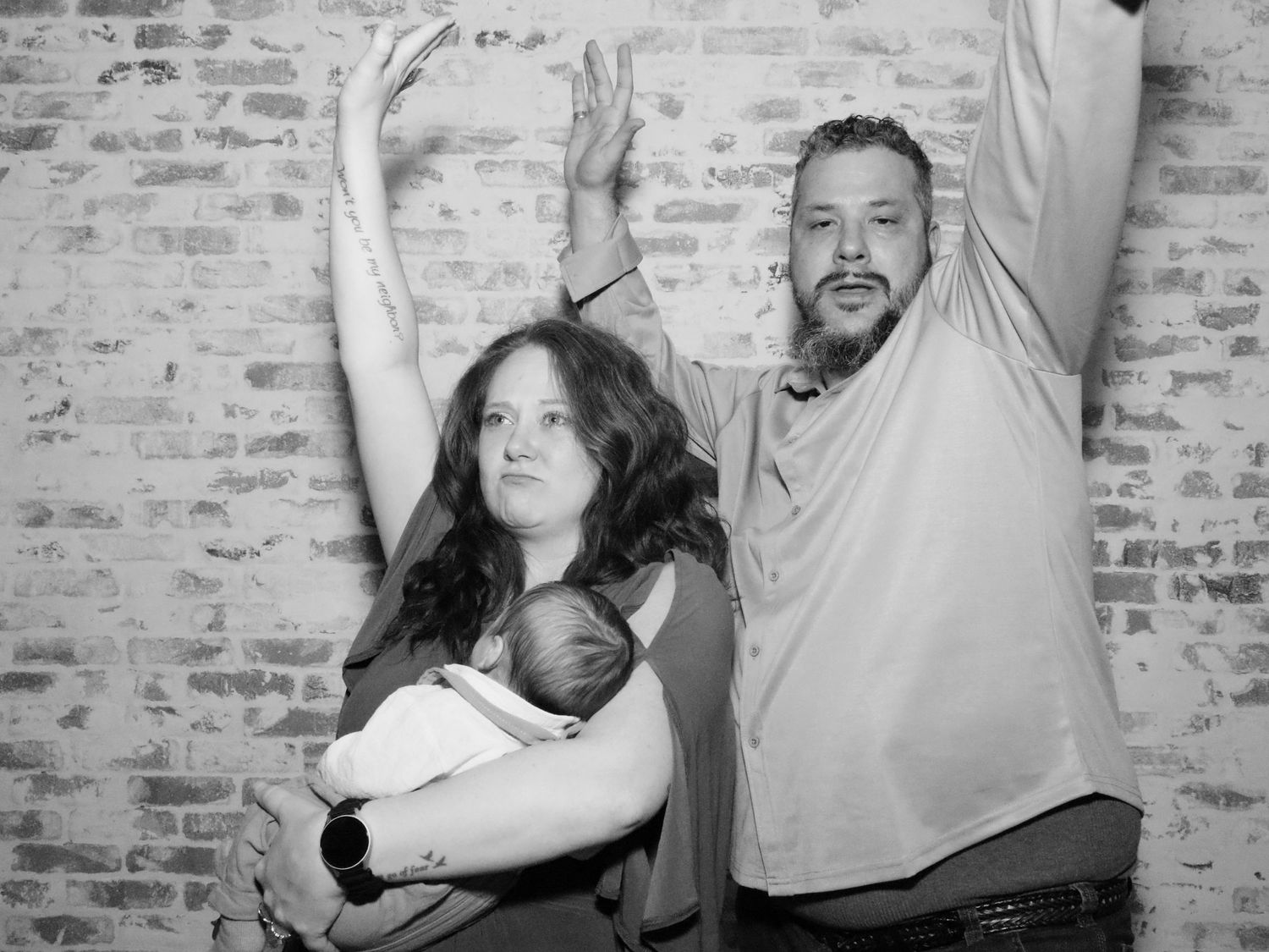 Candid moments of people hugging and celebrating against brick wall backdrop.