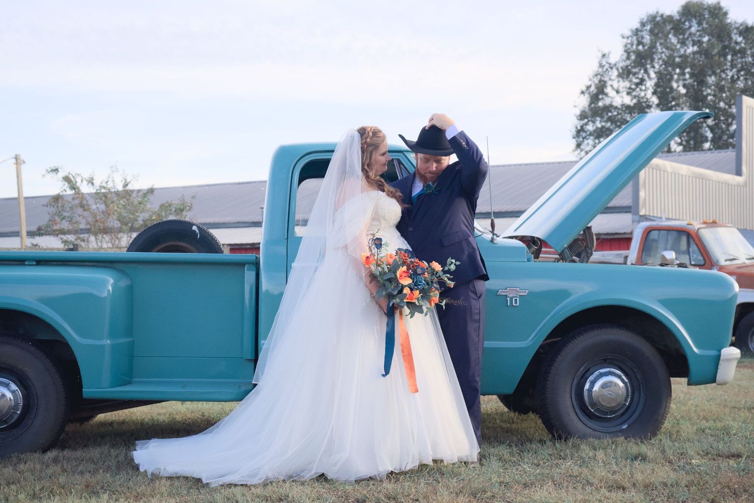 Rustic wedding photography series with classic turquoise pickup trucks in outdoor setting.