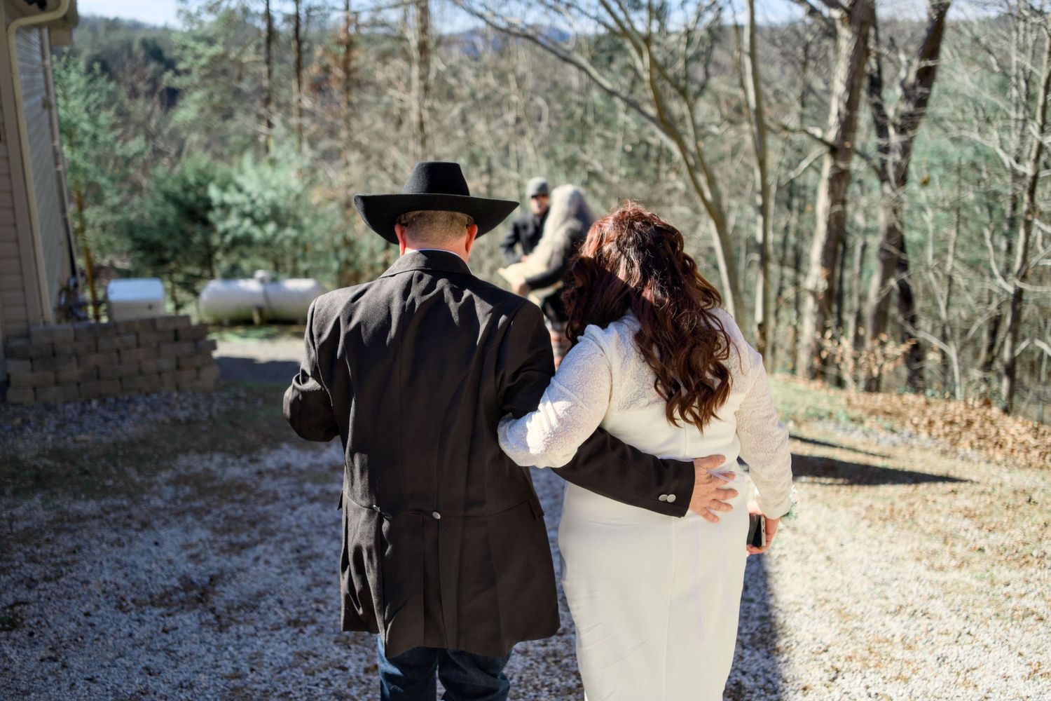 Couple walking through scenic mountain trail during engagement photoshoot.