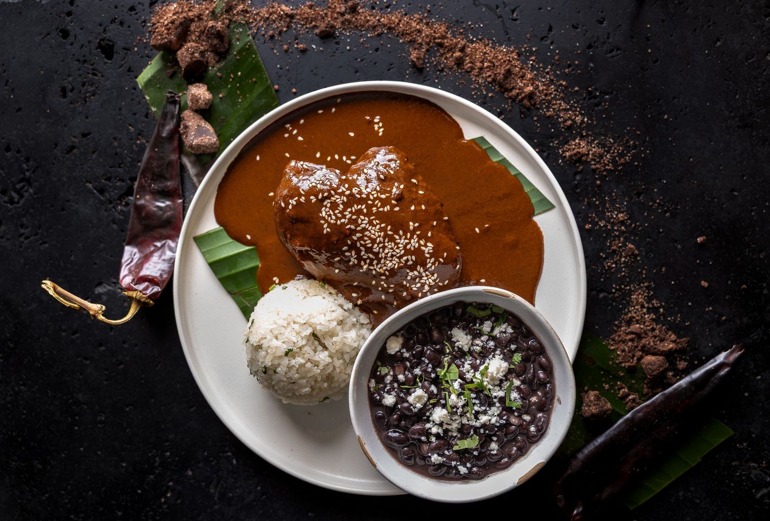 Elegant plated desserts featuring chocolate sauce, cream, and garnishes on white plates.