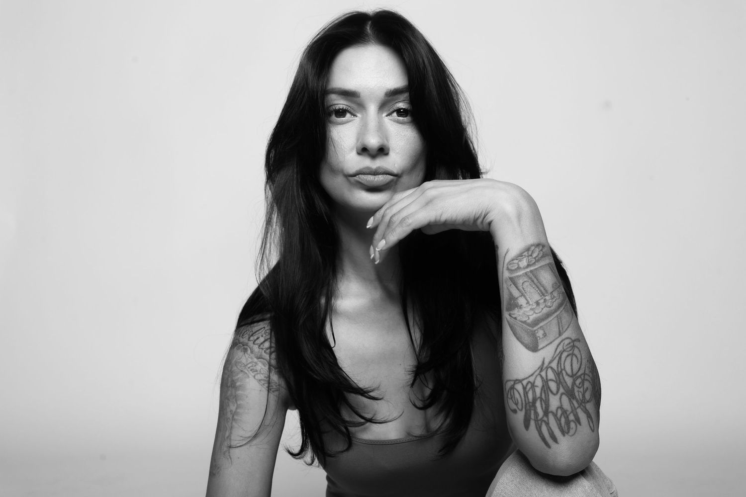 Black and white portrait series showing artistic poses against white background.