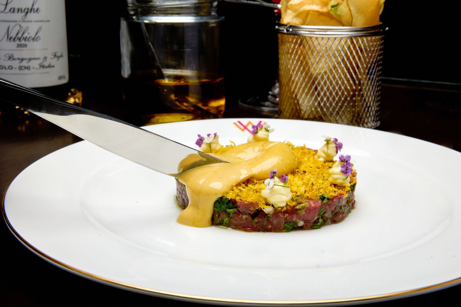 Elegantly plated fine dining dishes on white plates with artistic presentation.