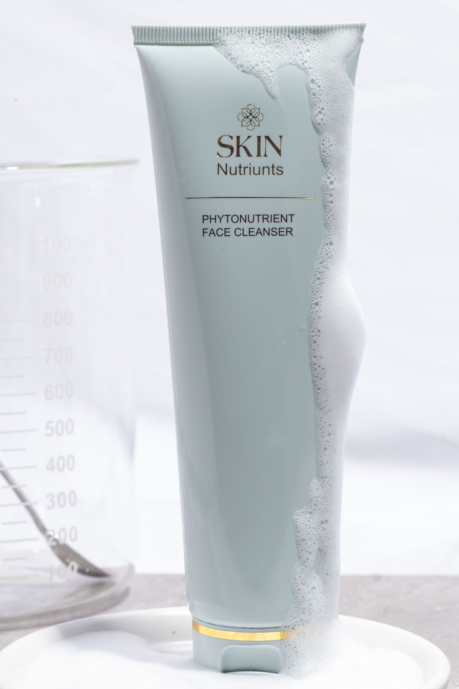 Light blue skincare tube with phytonutrient face cleanser text displayed on white background.