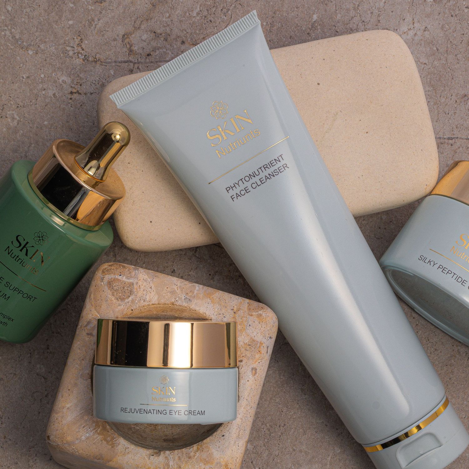 High-end beauty products and cream jars arranged with natural stone decor elements.
