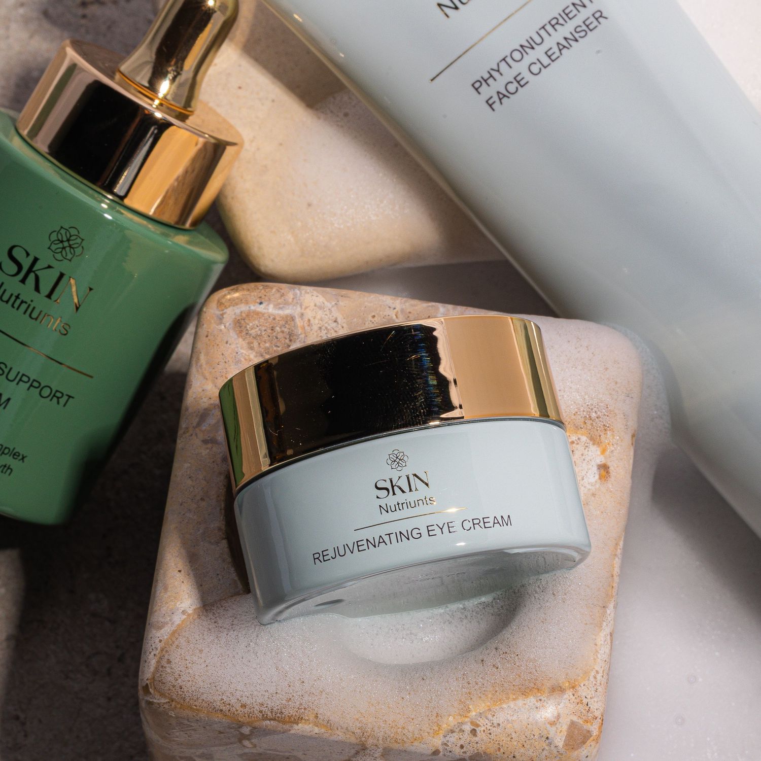 Luxury SKA skincare products including green serum and cream jars on textured surface.