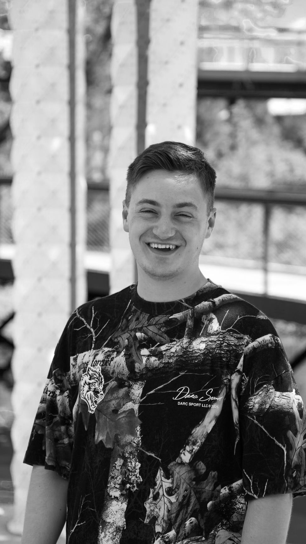 Black and white Headshot portrait of man smiling in park