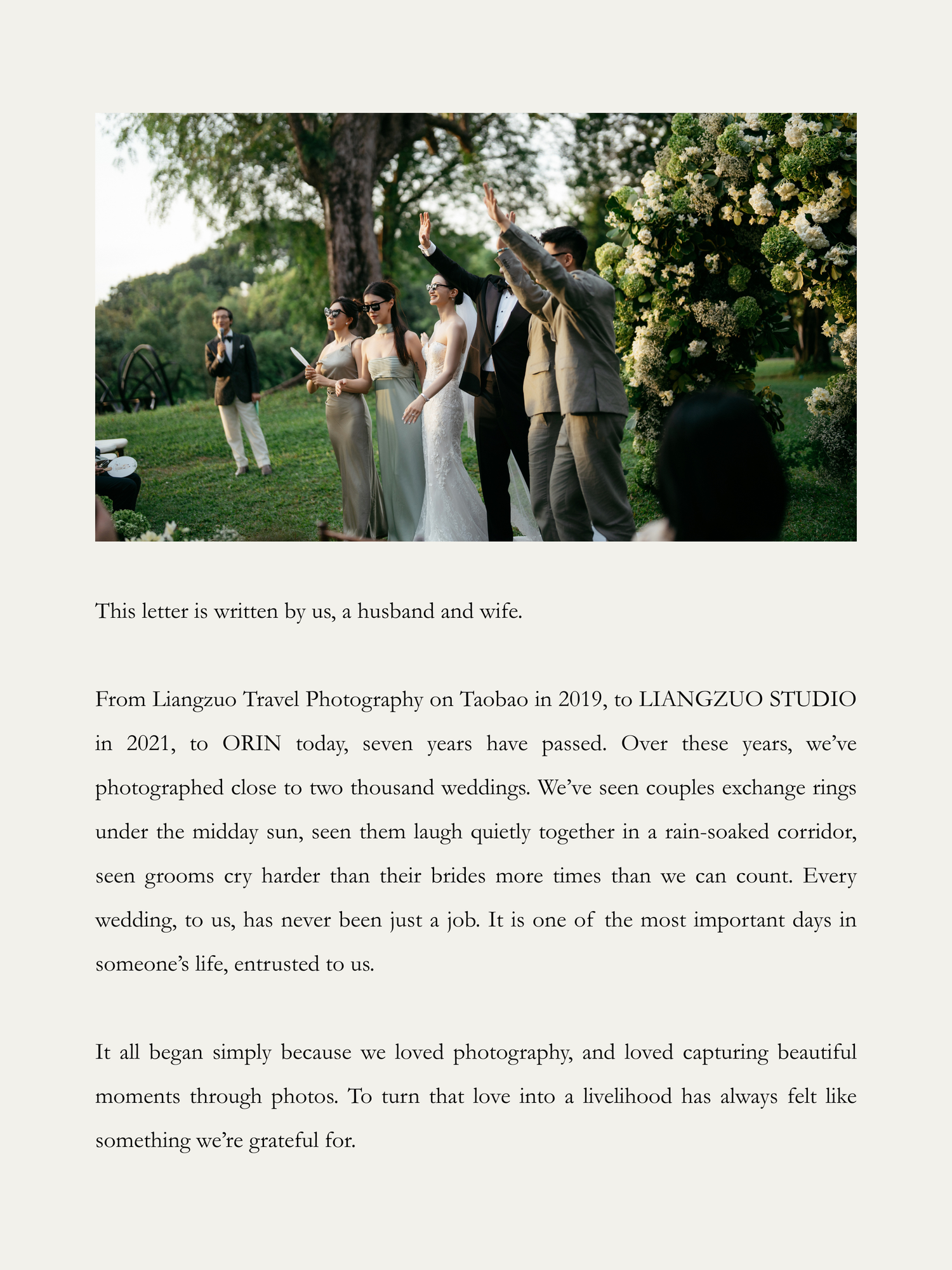 Outdoor wedding ceremony with couple exchanging rings surrounded by lush greenery and wedding party in elegant attire.