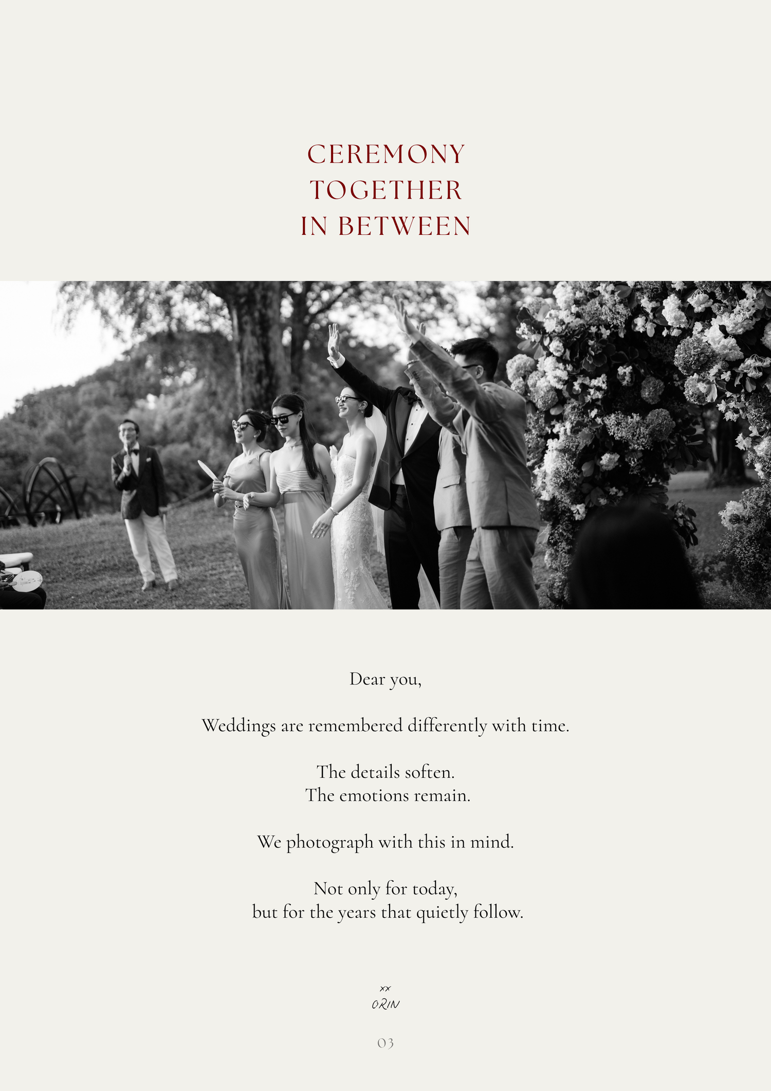 Black and white wedding photo of couple sharing a kiss during outdoor ceremony surrounded by guests and floral arrangements.