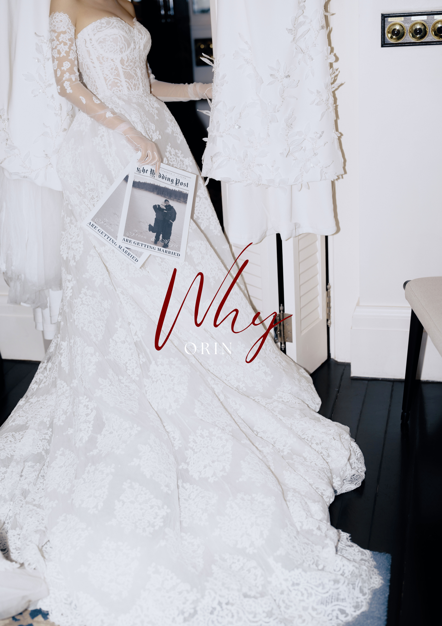 Bride in elegant white lace wedding gown holding a newspaper, with flowing skirt and delicate embroidery details.