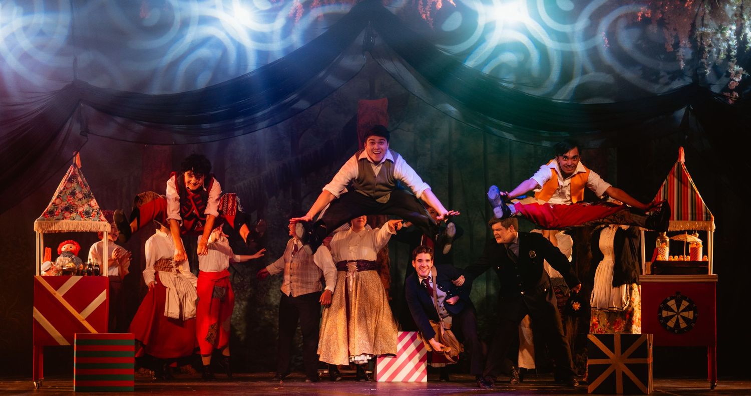 Colorful theatrical stage performance with costumed actors and vibrant lighting in a dramatic holiday play.